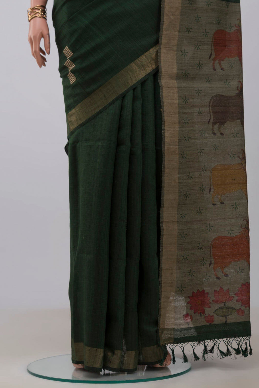 Pleats and pallu of Green Tussar Silk Saree with Thread Butta on the body and Zari Border. 
