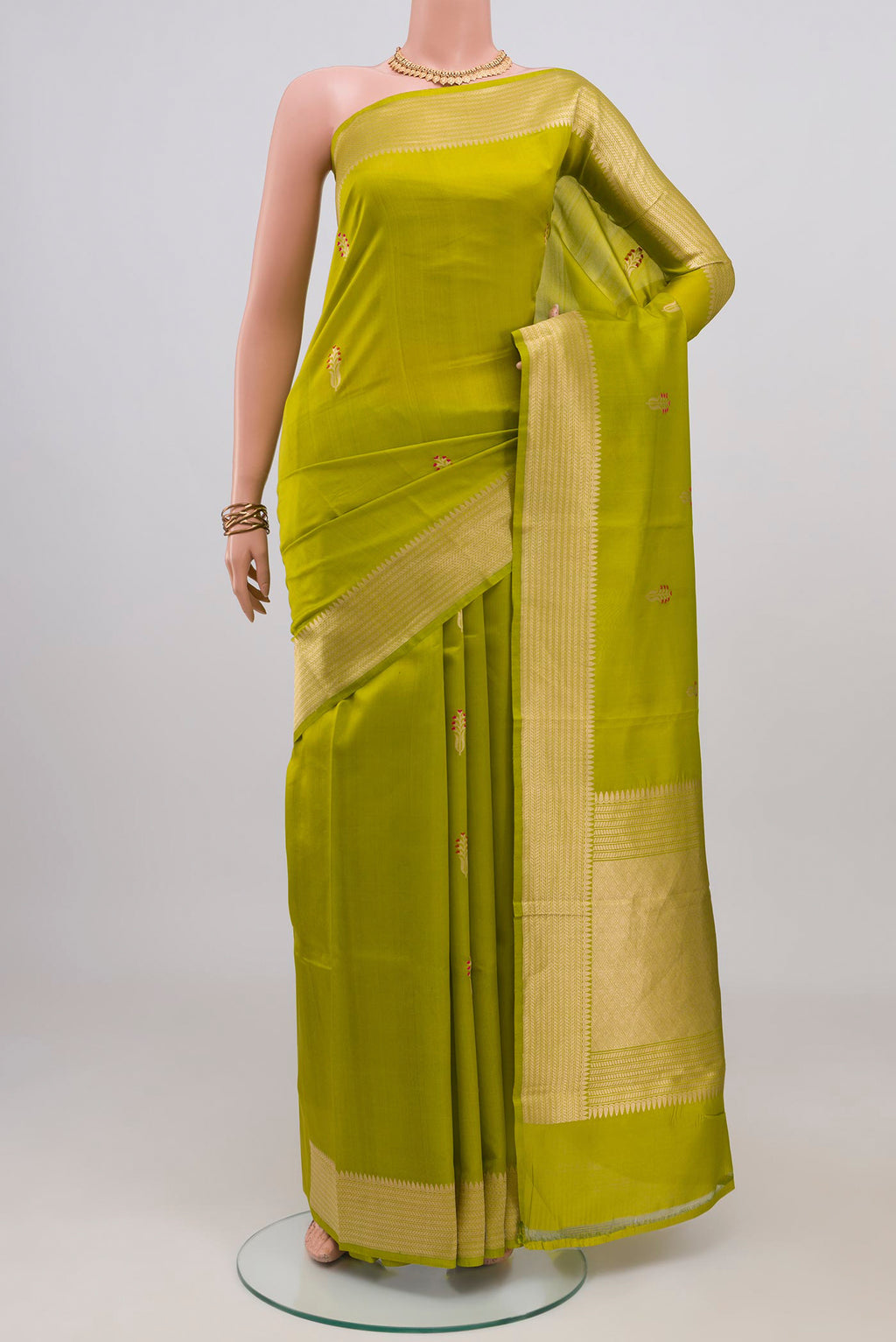 Parrot Green Banarasi Katan Silk Saree with Zari Butta on the body and Fancy Border.  displayed on a mannequin