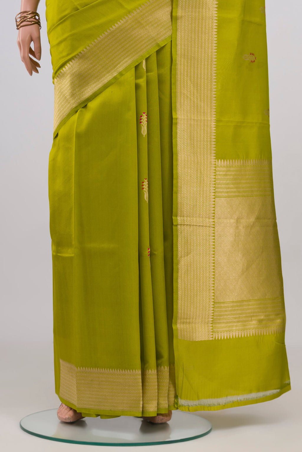 Pleats and pallu of Parrot Green Banarasi Katan Silk Saree with Zari Butta on the body and Fancy Border. 
