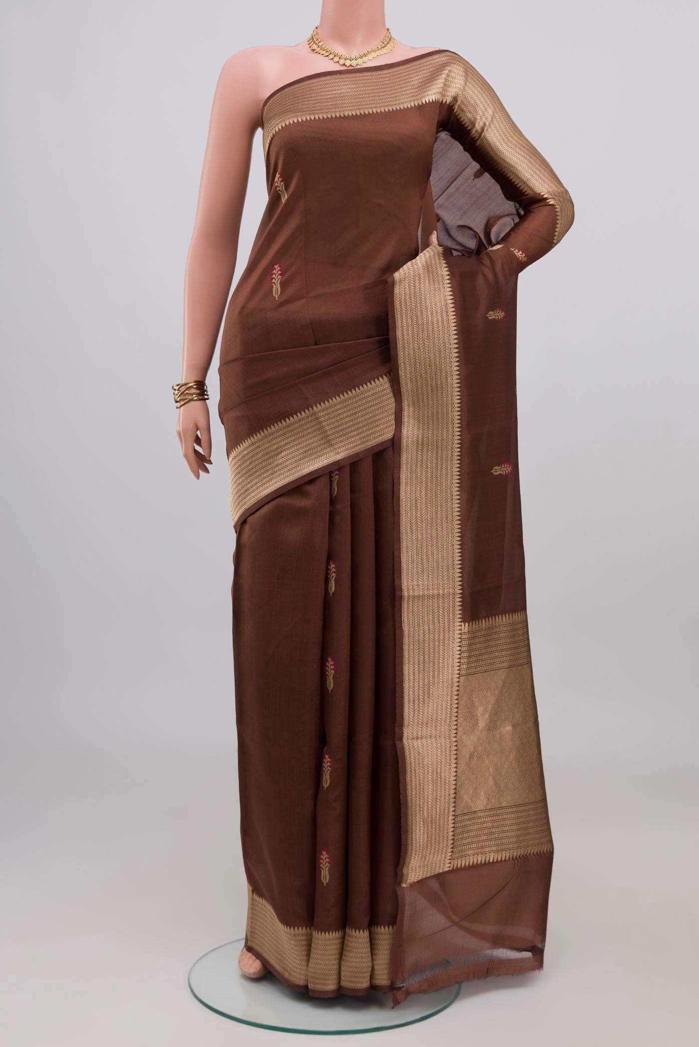 Brown Banarasi Katan Silk Saree with Zari Butta on the body and Zari Border.  displayed on a mannequin