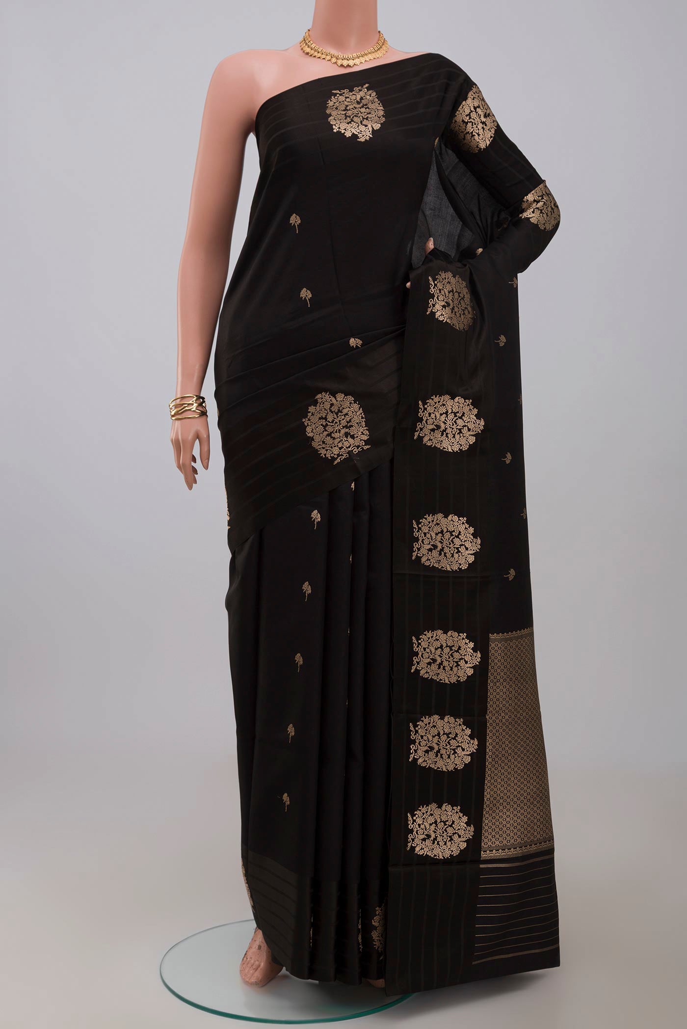 Black Banarasi Katan Silk Saree with Zari Butta on the body and Fancy Border.  displayed on a mannequin