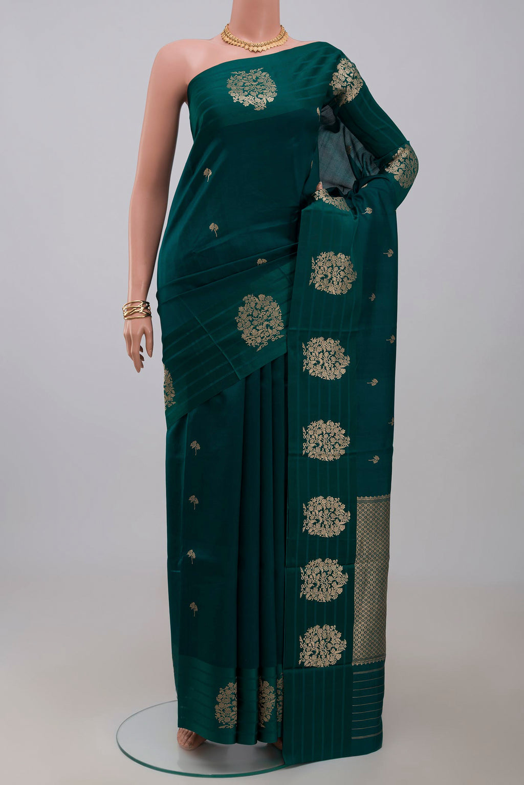 Green Banarasi Katan Silk Saree with Zari Butta on the body and Fancy Border.  displayed on a mannequin
