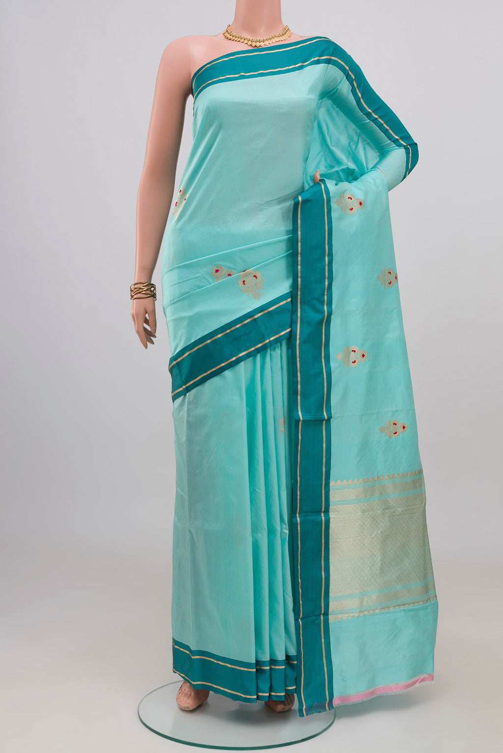 Sky Blue Banarasi Katan Silk Saree with Zari Butta on the body and Plain Border.  displayed on a mannequin