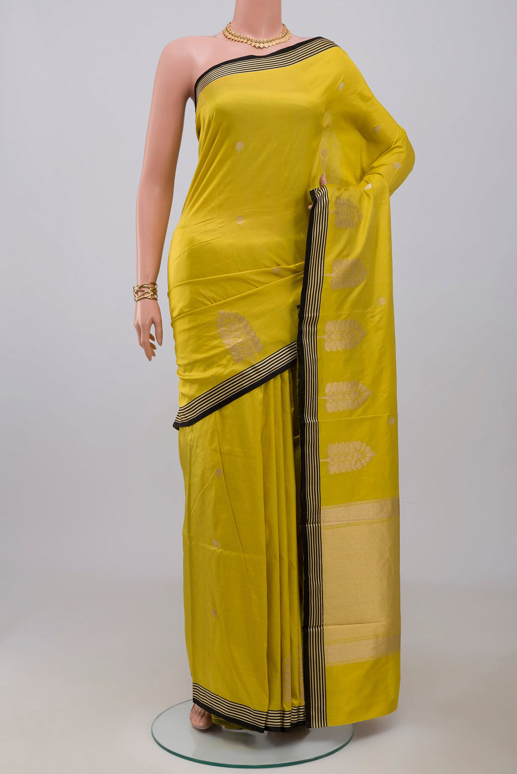 Lemon Yellow Banarasi Katan Silk Saree with Zari Butta on the body and Fancy Border.  displayed on a mannequin