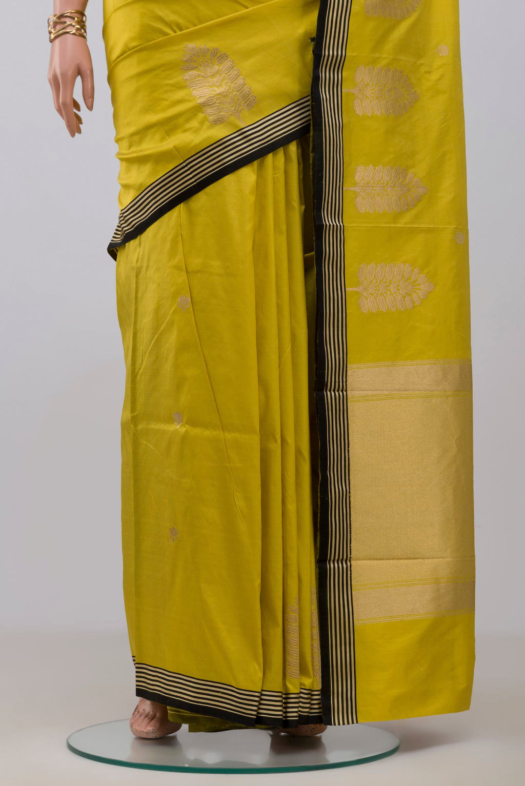 Pleats and pallu of Lemon Yellow Banarasi Katan Silk Saree with Zari Butta on the body and Fancy Border. 