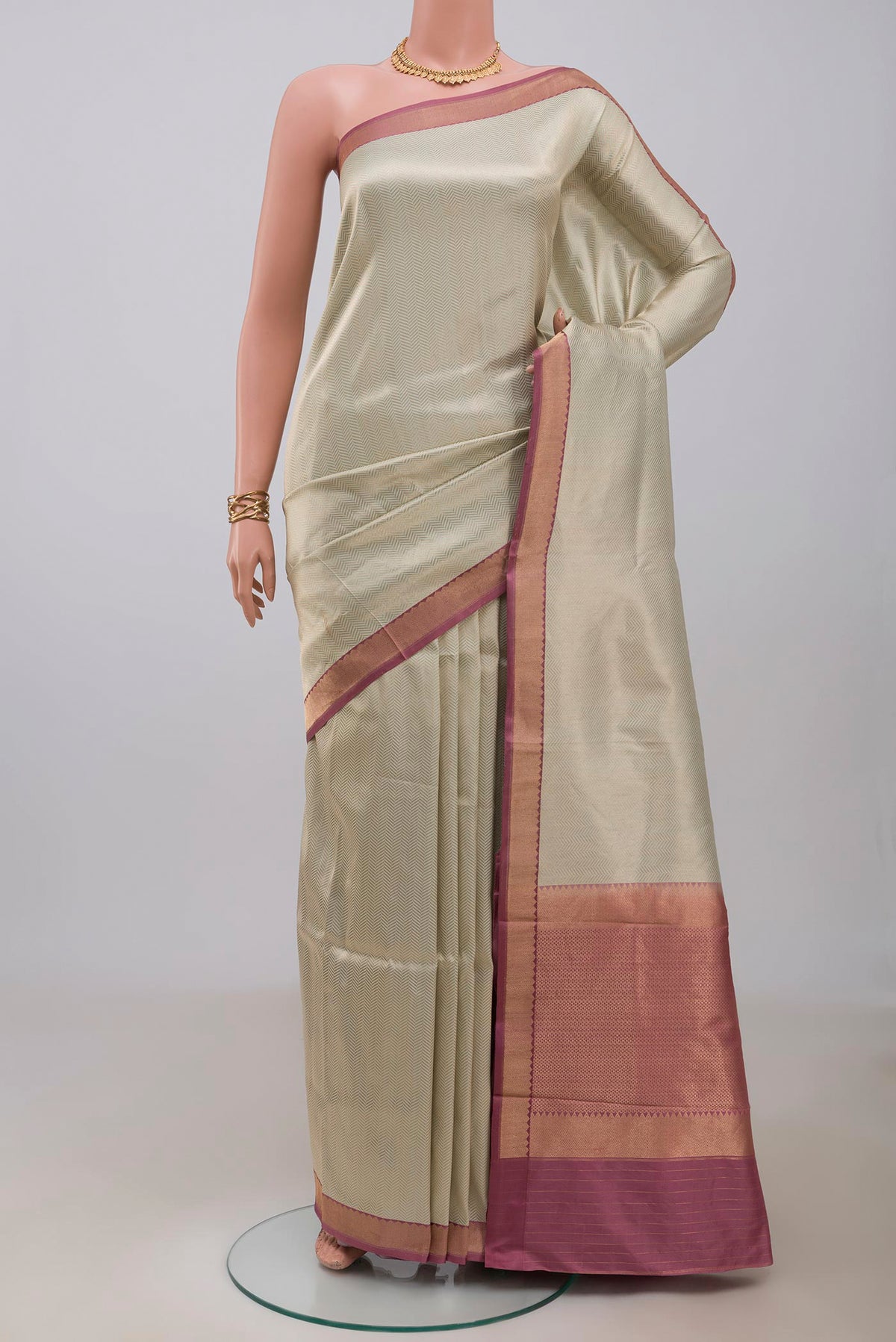 Cream Banarasi Katan Silk Saree with Zari Brocade on the body and Zari Border.  displayed on a mannequin
