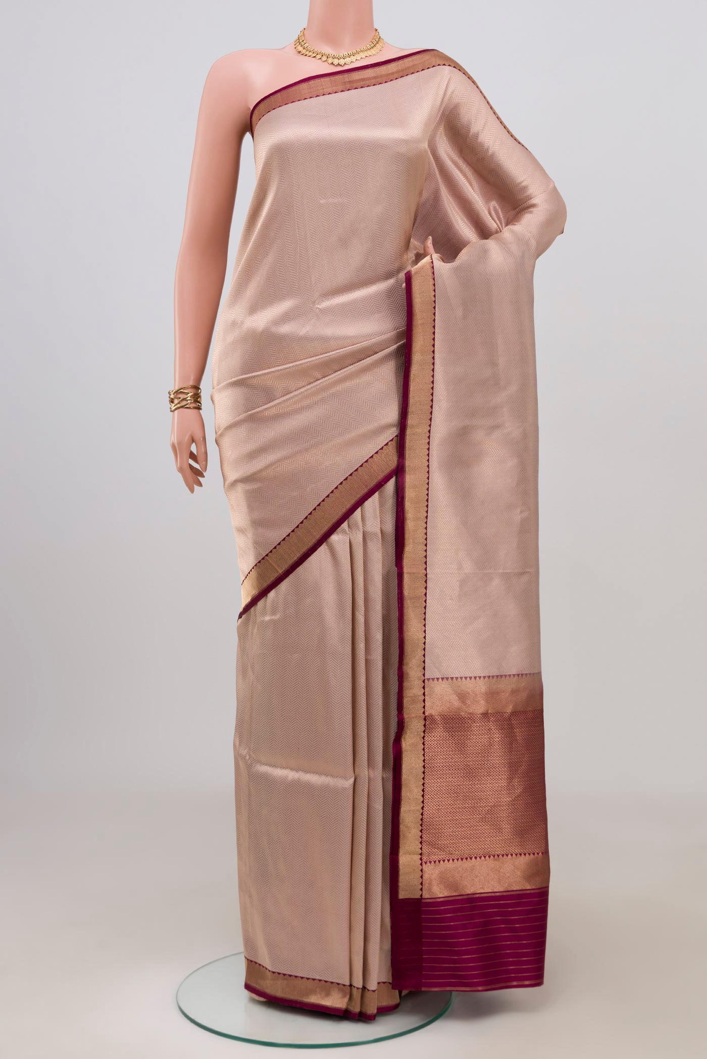 Rose Gold Banarasi Katan Silk Saree with Zari Brocade on the body and Zari Border.  displayed on a mannequin