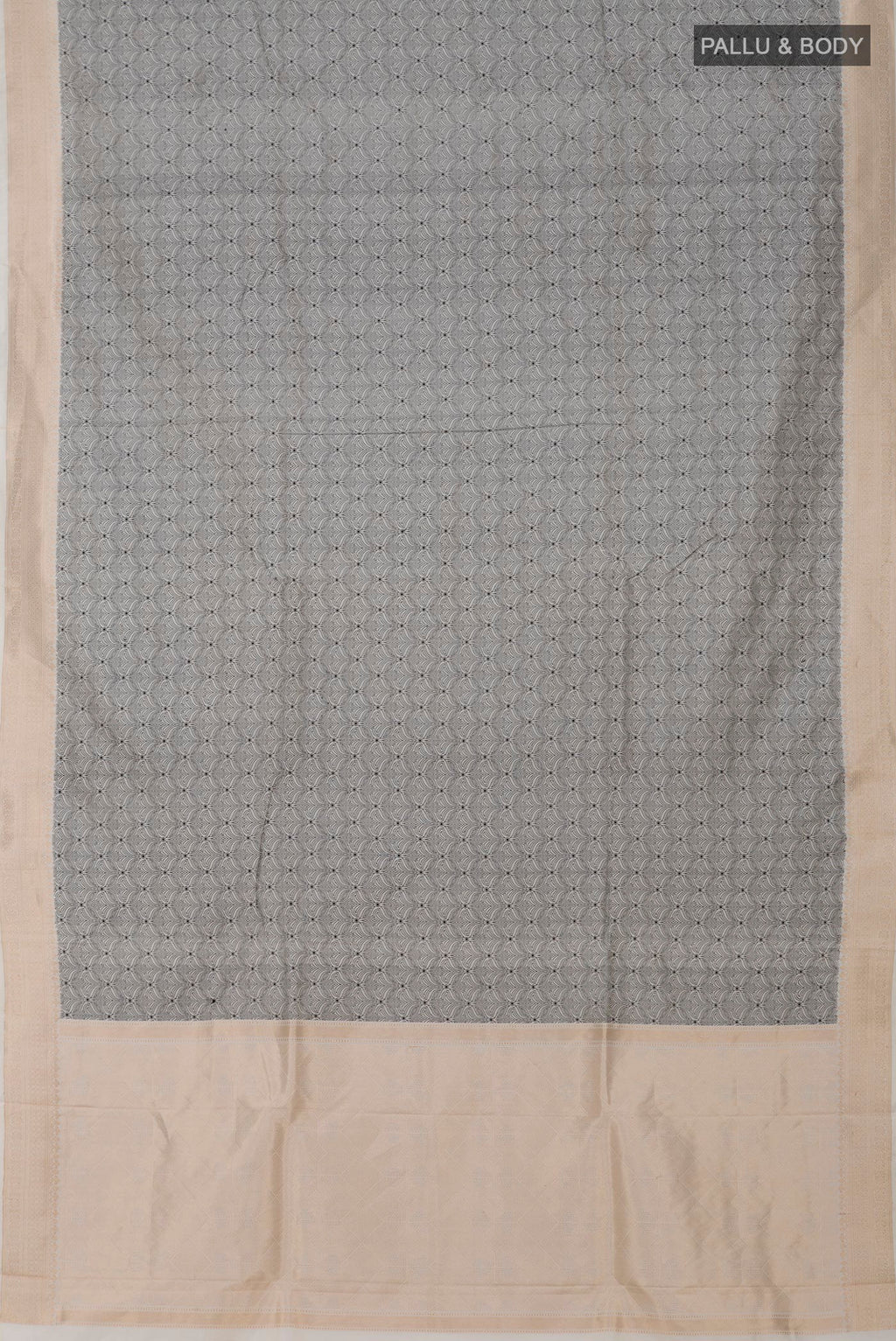 Flat view of Cream Banarasi Katan Silk Saree with Jacquard design on the body and Zari Border. 