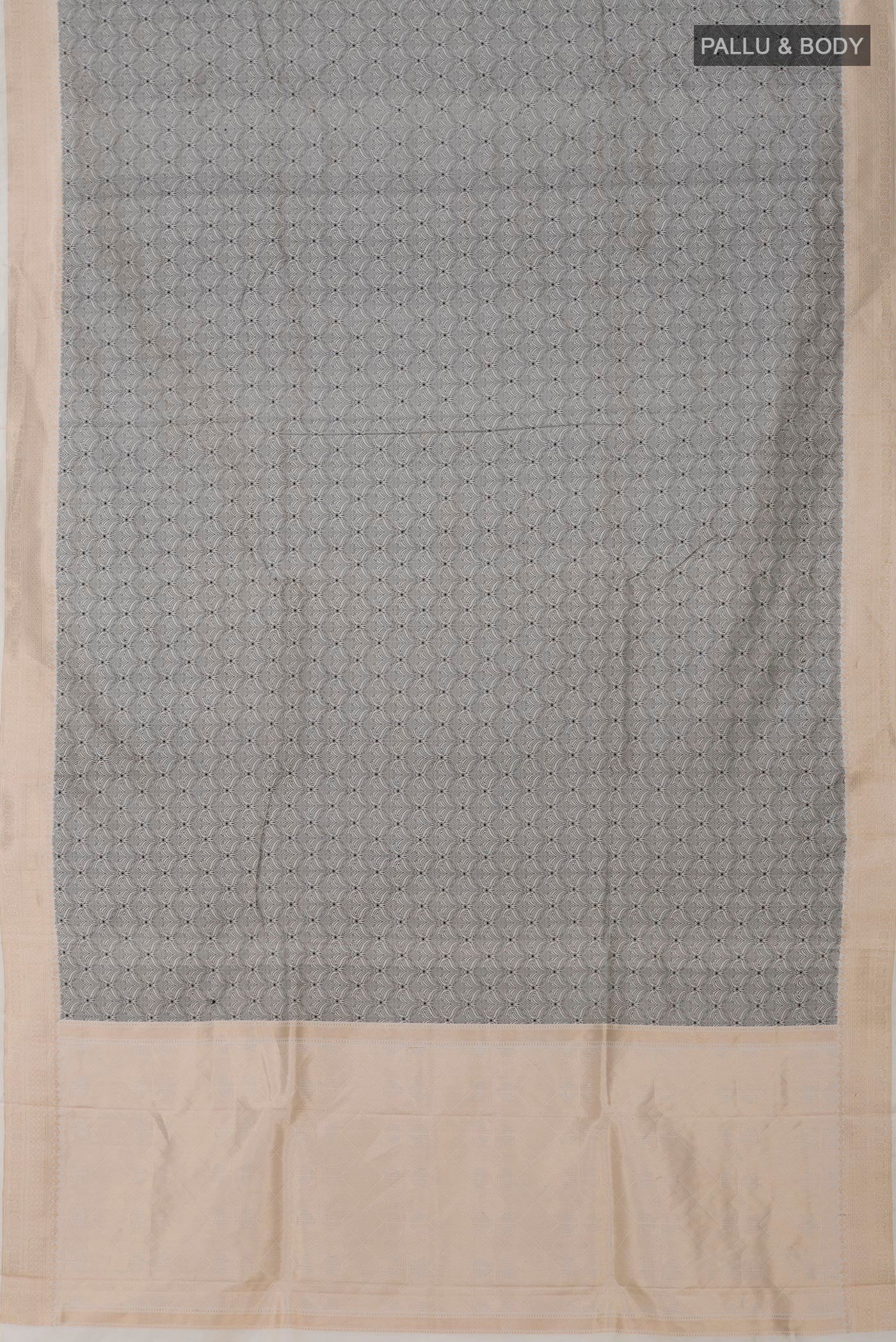 Flat view of Cream Banarasi Katan Silk Saree with Jacquard design on the body and Zari Border. 