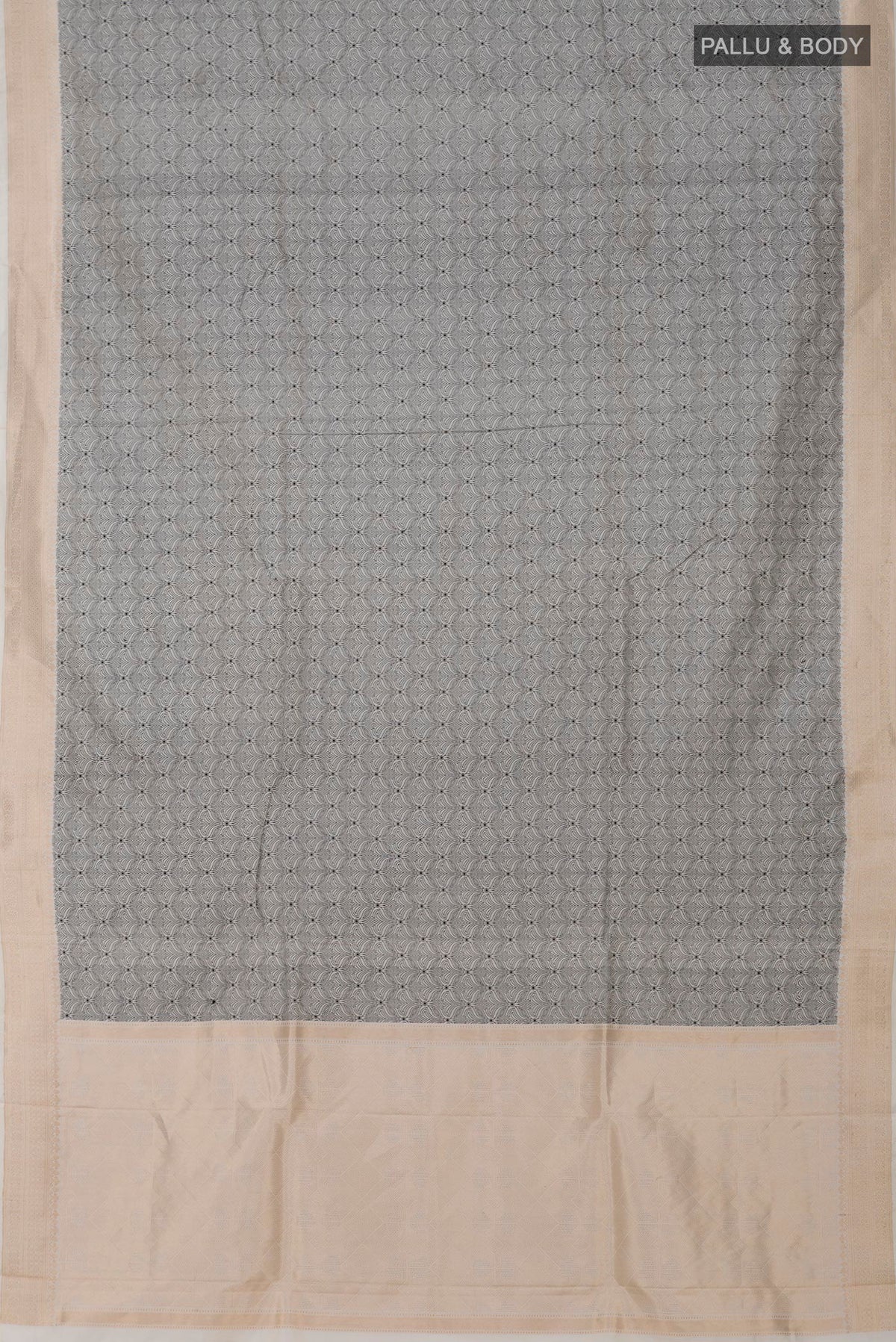 Flat view of Cream Banarasi Katan Silk Saree with Jacquard design on the body and Zari Border. 