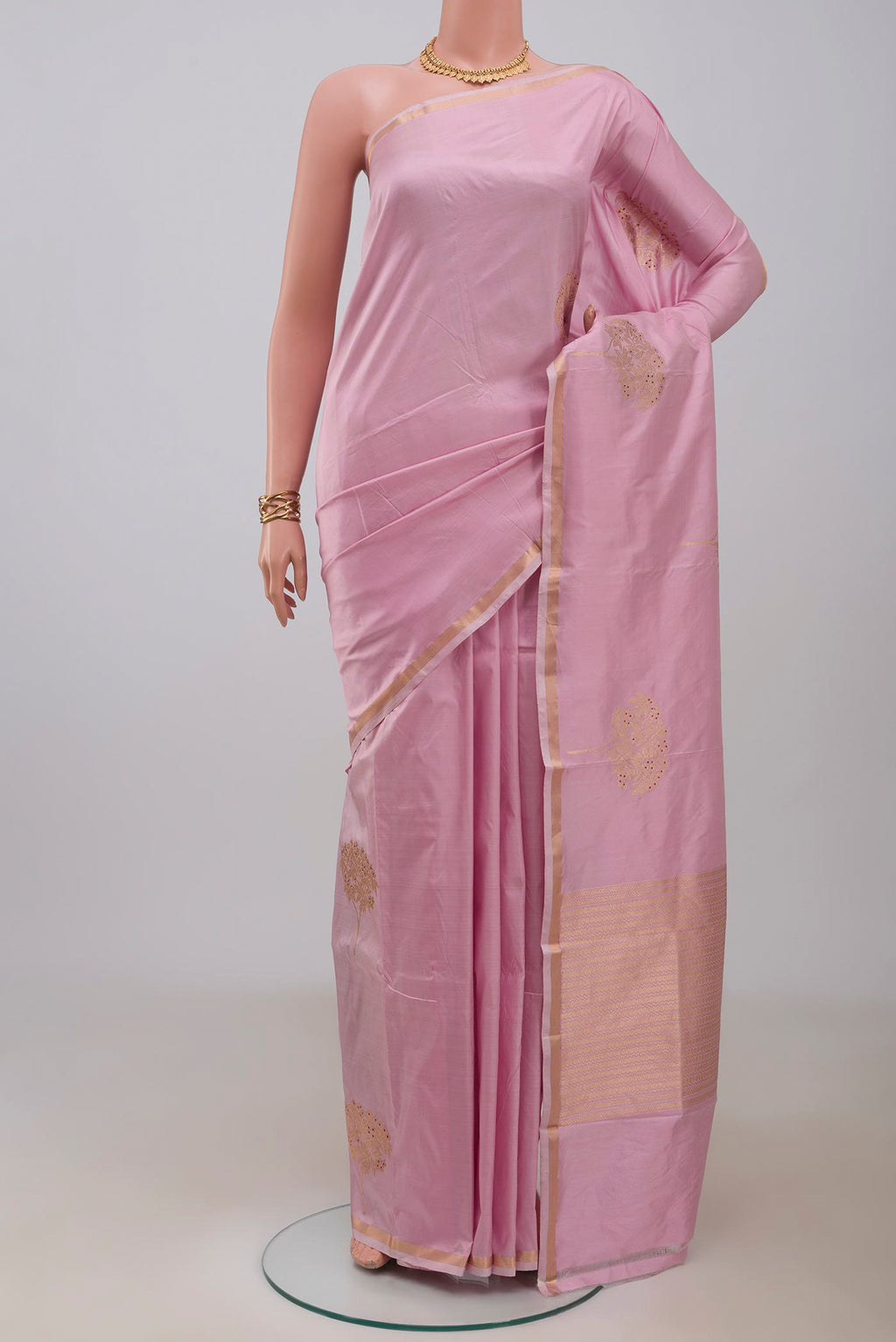 Rose pink Banarasi Katan Silk Saree with Zari Butta on the body and Thin Zari Line.  displayed on a mannequin