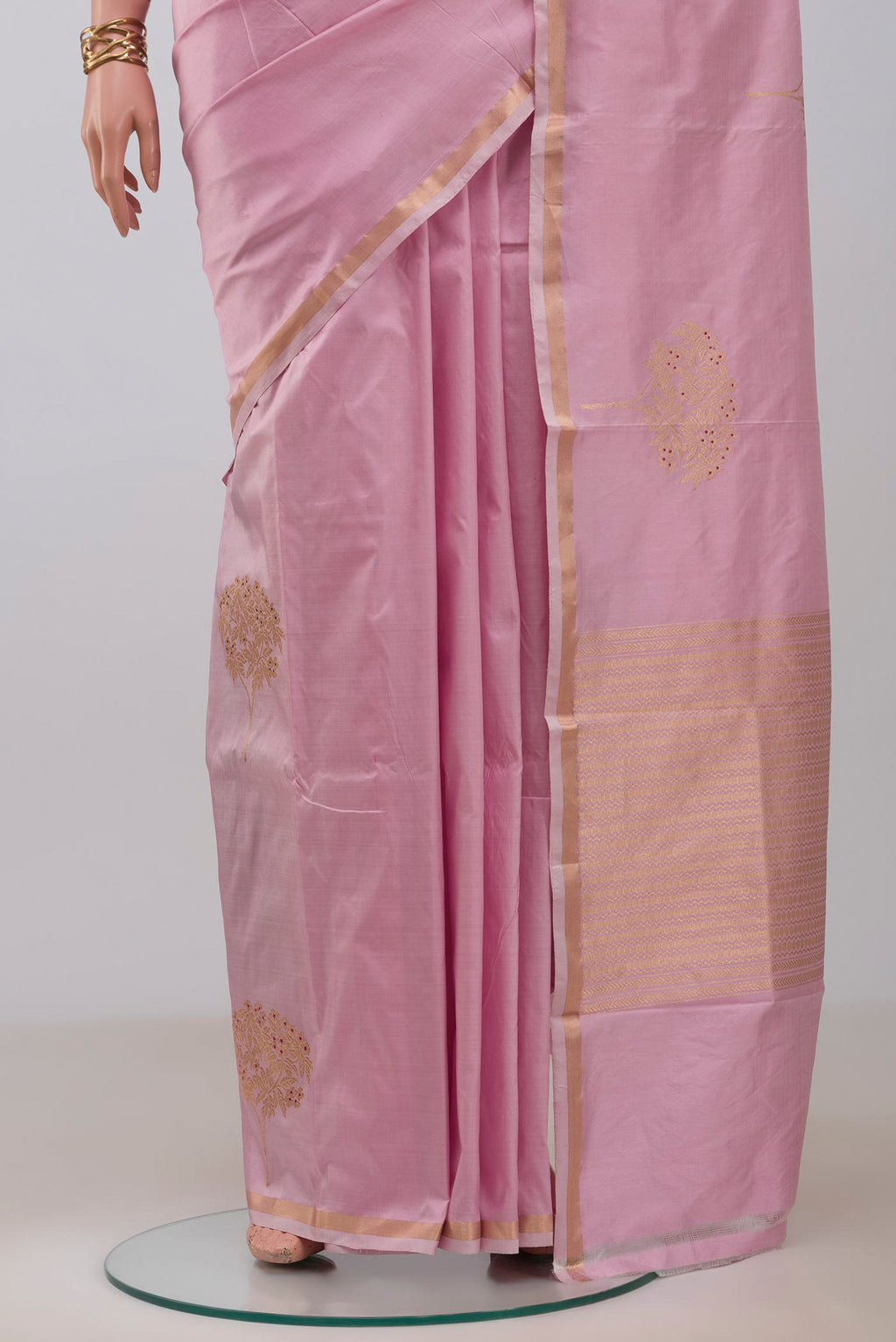 Pleats and pallu of Rose pink Banarasi Katan Silk Saree with Zari Butta on the body and Thin Zari Line. 