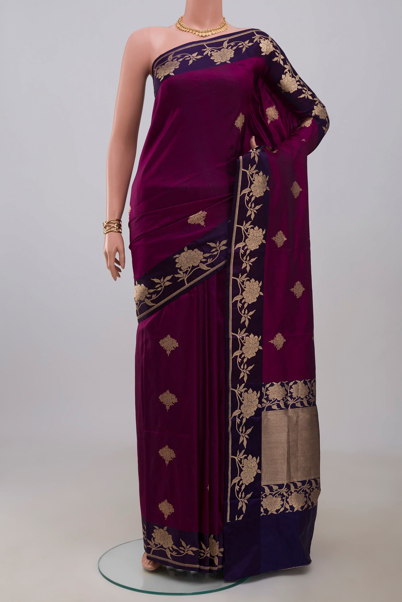 Purple Banarasi Katan Silk Saree with Zari Butta on the body and Fancy Border.  displayed on a mannequin