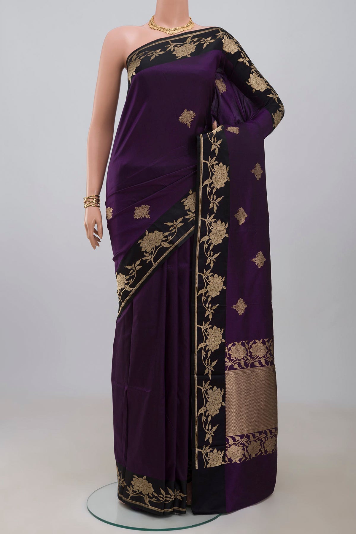 Purple Banarasi Katan Silk Saree with Zari Butta on the body and Fancy Border.  displayed on a mannequin