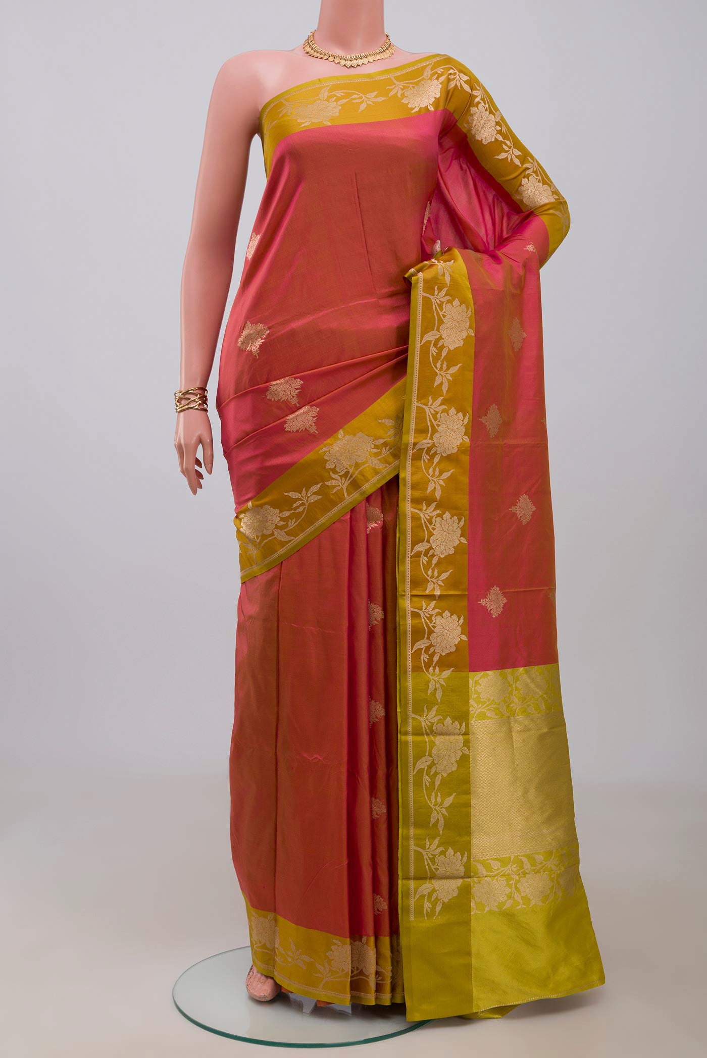 Pink Banarasi Katan Silk Saree with Zari Butta on the body and Fancy Border.  displayed on a mannequin