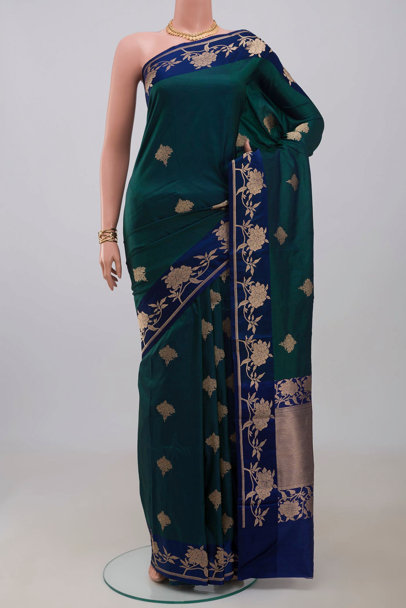 Peacock Blue Banarasi Katan Silk Saree with Zari Butta on the body and Fancy Border.  displayed on a mannequin