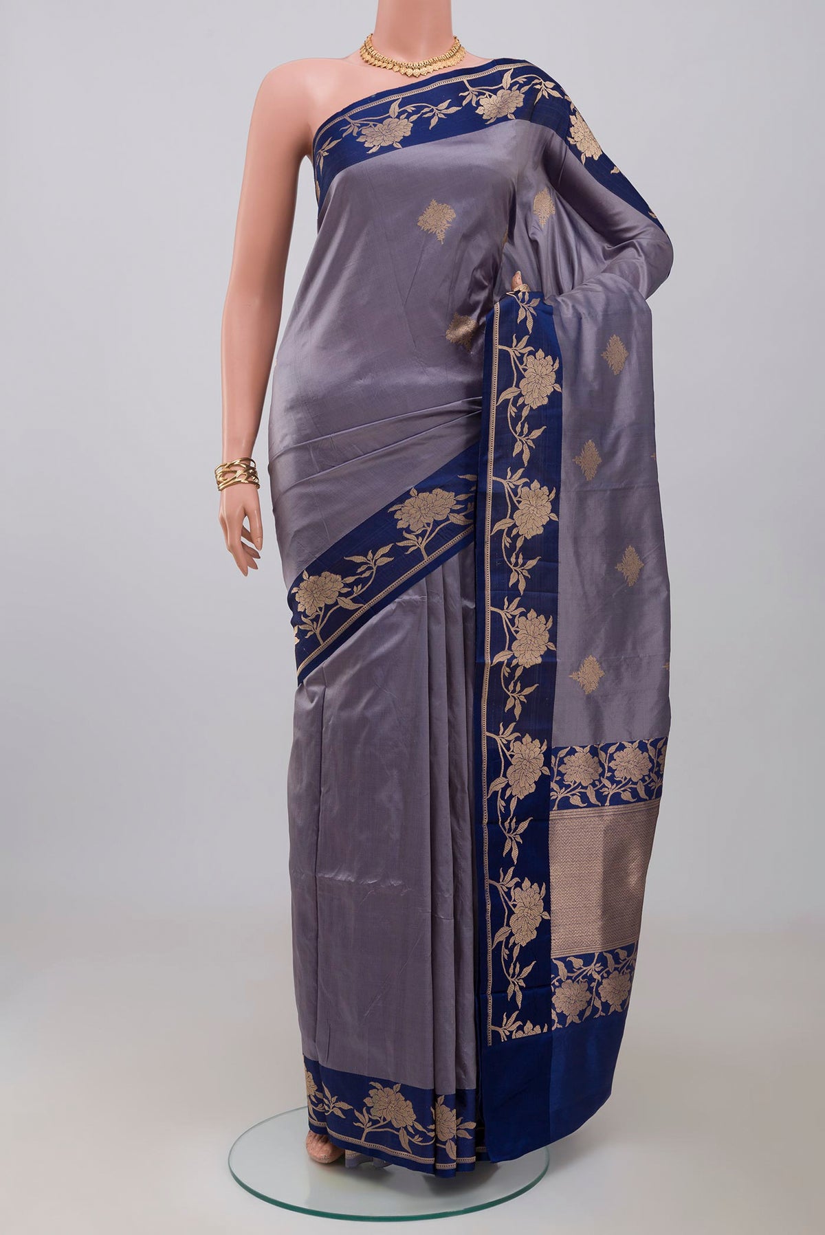Blue Grey Banarasi Katan Silk Saree with Zari Butta on the body and Fancy Border.  displayed on a mannequin