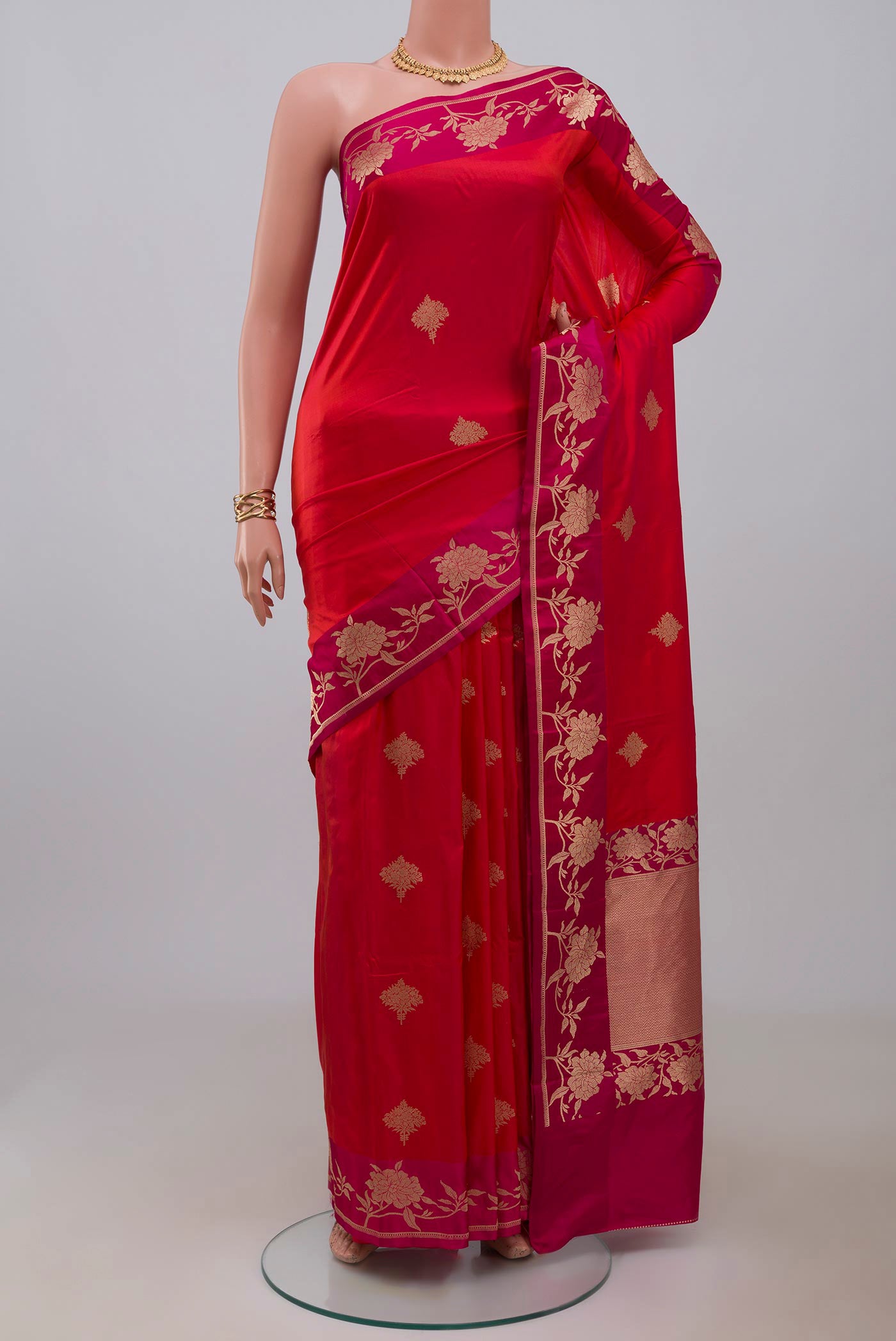 Pink Banarasi Katan Silk Saree with Zari Butta on the body and Fancy Border.  displayed on a mannequin