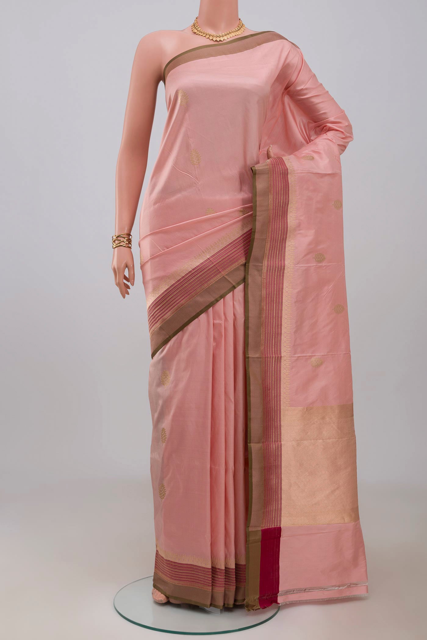 Rose Gold Banarasi Katan Silk Saree with Zari Butta on the body and Fancy Border.  displayed on a mannequin