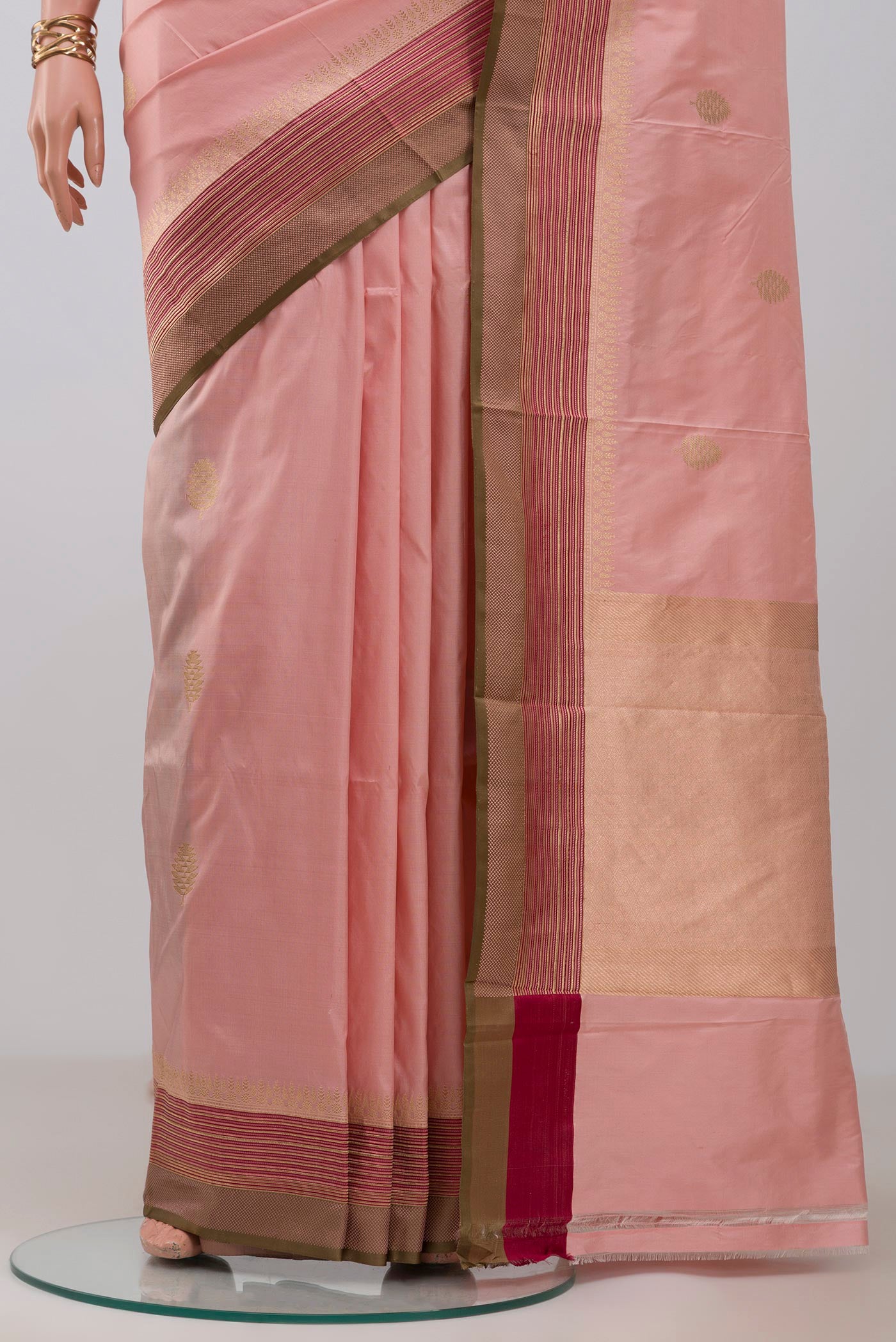 Pleats and pallu of Rose Gold Banarasi Katan Silk Saree with Zari Butta on the body and Fancy Border. 