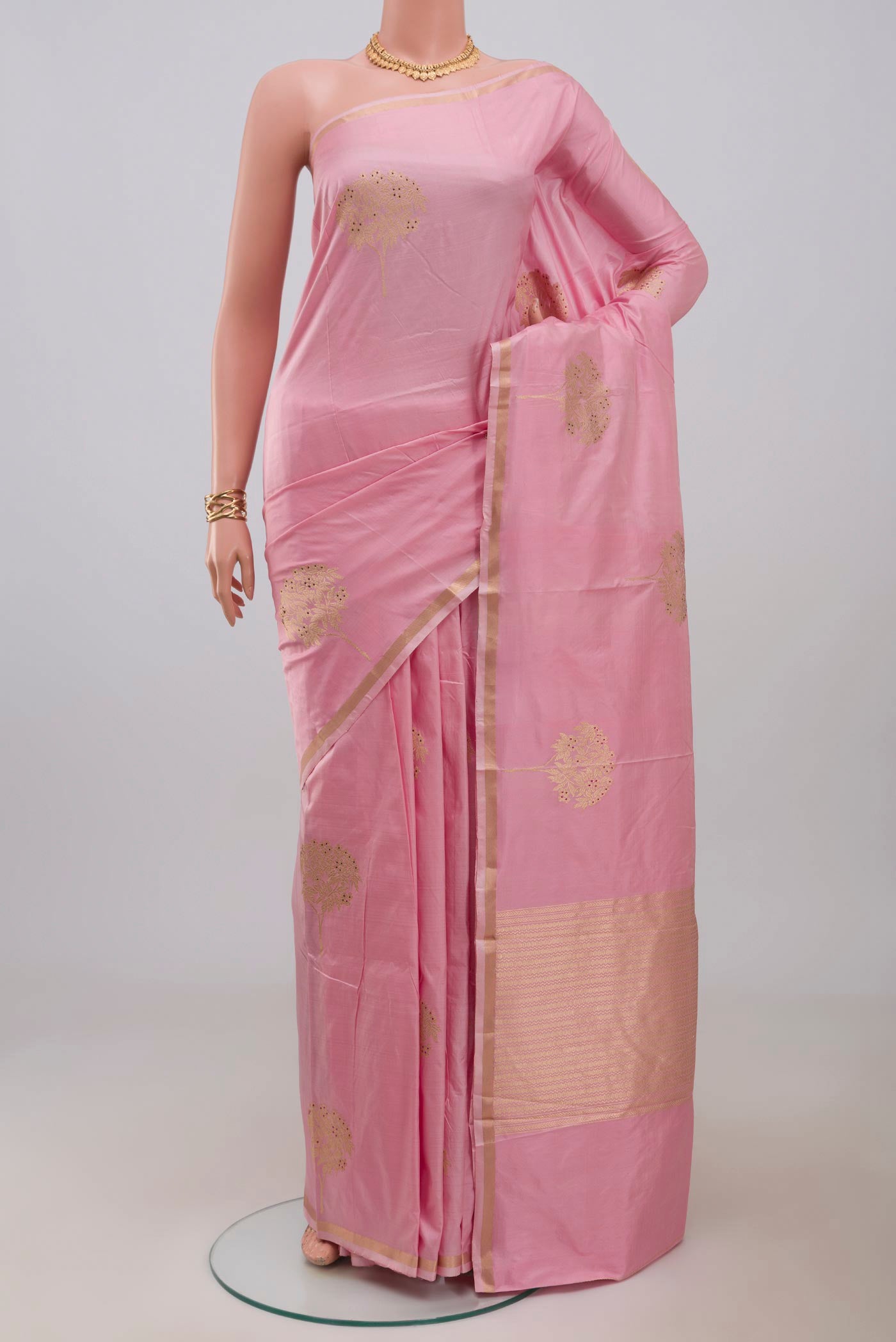 Pink Banarasi Katan Silk Saree with Zari Butta on the body and Thin Zari Line.  displayed on a mannequin
