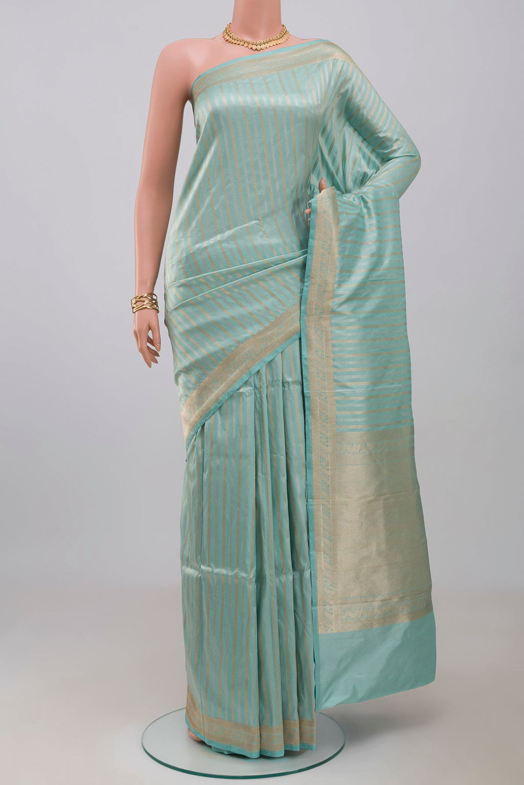 Sky Blue Banarasi Katan Silk Saree with Stripes on the body and Fancy Border.  displayed on a mannequin
