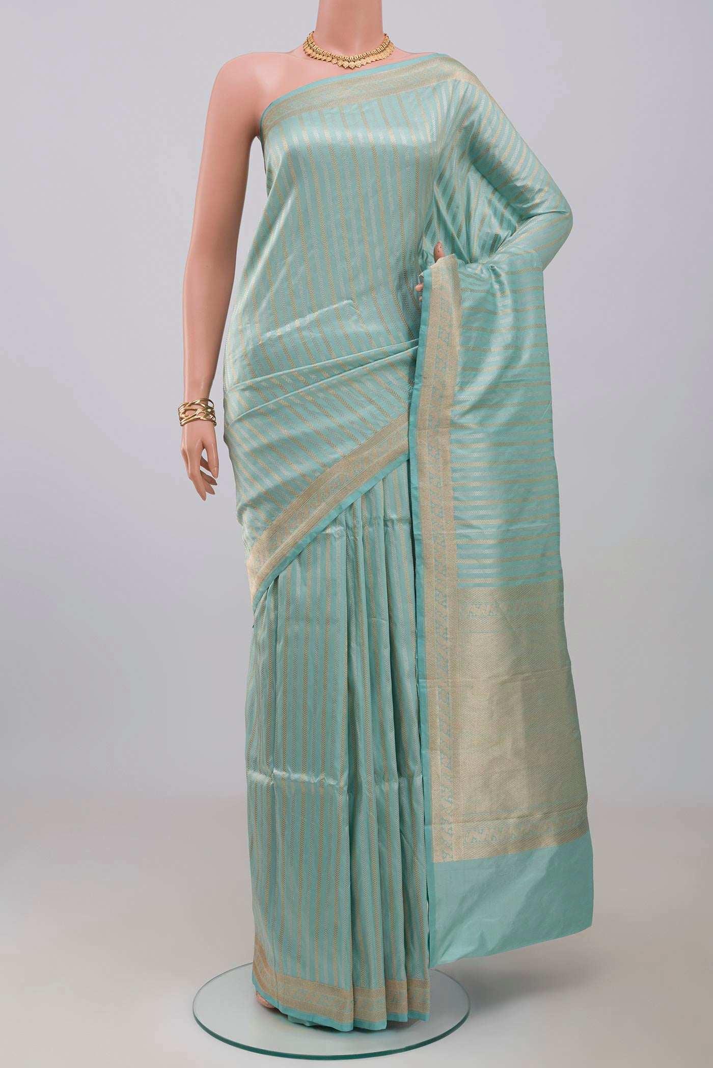 Sky Blue Banarasi Katan Silk Saree with Stripes on the body and Fancy Border.  displayed on a mannequin