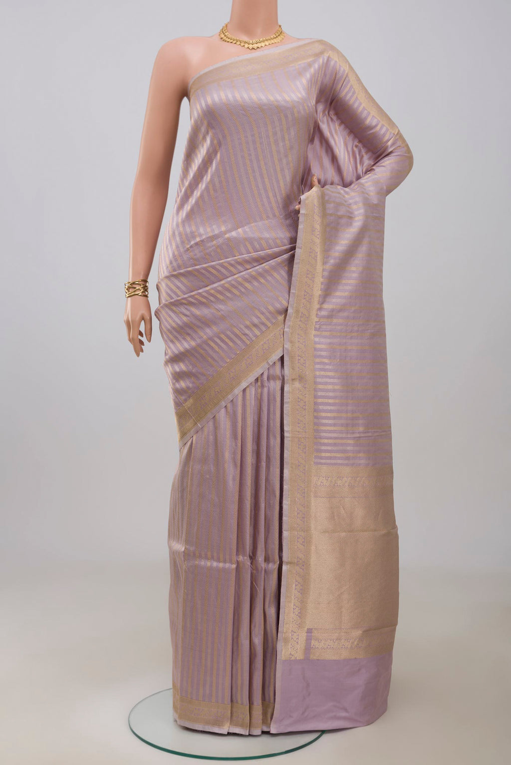 Lavender Banarasi Katan Silk Saree with Stripes on the body and Zari Border.  displayed on a mannequin