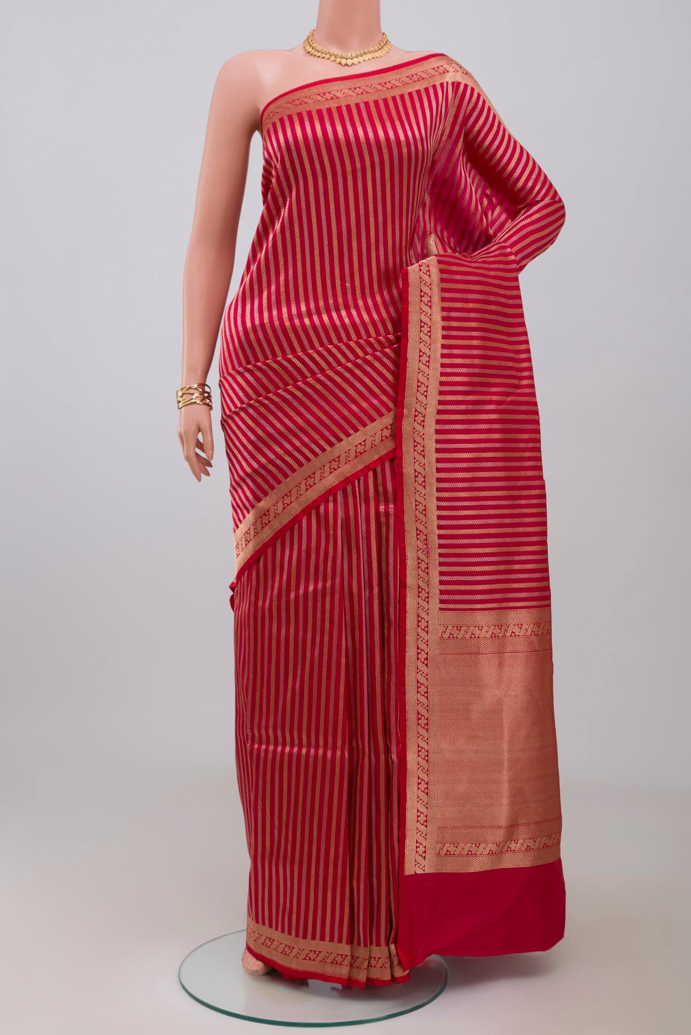 Red Banarasi Katan Silk Saree with Stripes on the body and Fancy Border.  displayed on a mannequin