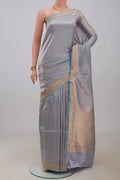 Light Blue Banarasi Katan Silk Saree with Stripes on the body and Zari Border.  displayed on a mannequin