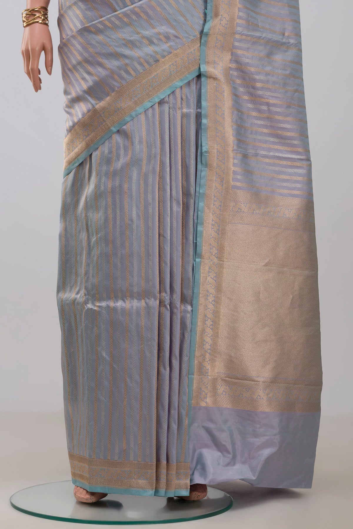 Pleats and pallu of Light Blue Banarasi Katan Silk Saree with Stripes on the body and Zari Border. 