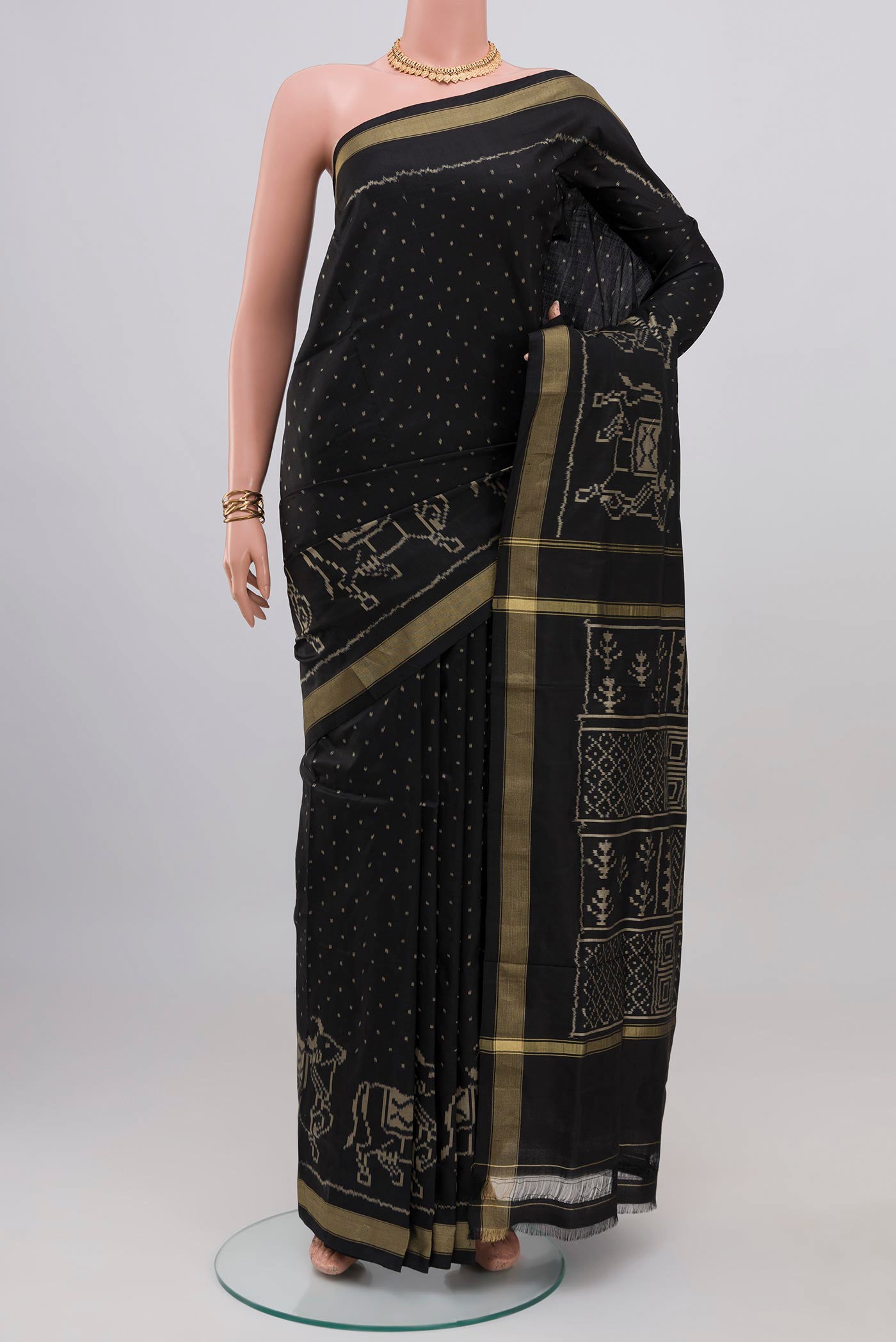 Black Pochampally Silk Saree with Ikat design on the body and Thin Zari Line.  displayed on a mannequin
