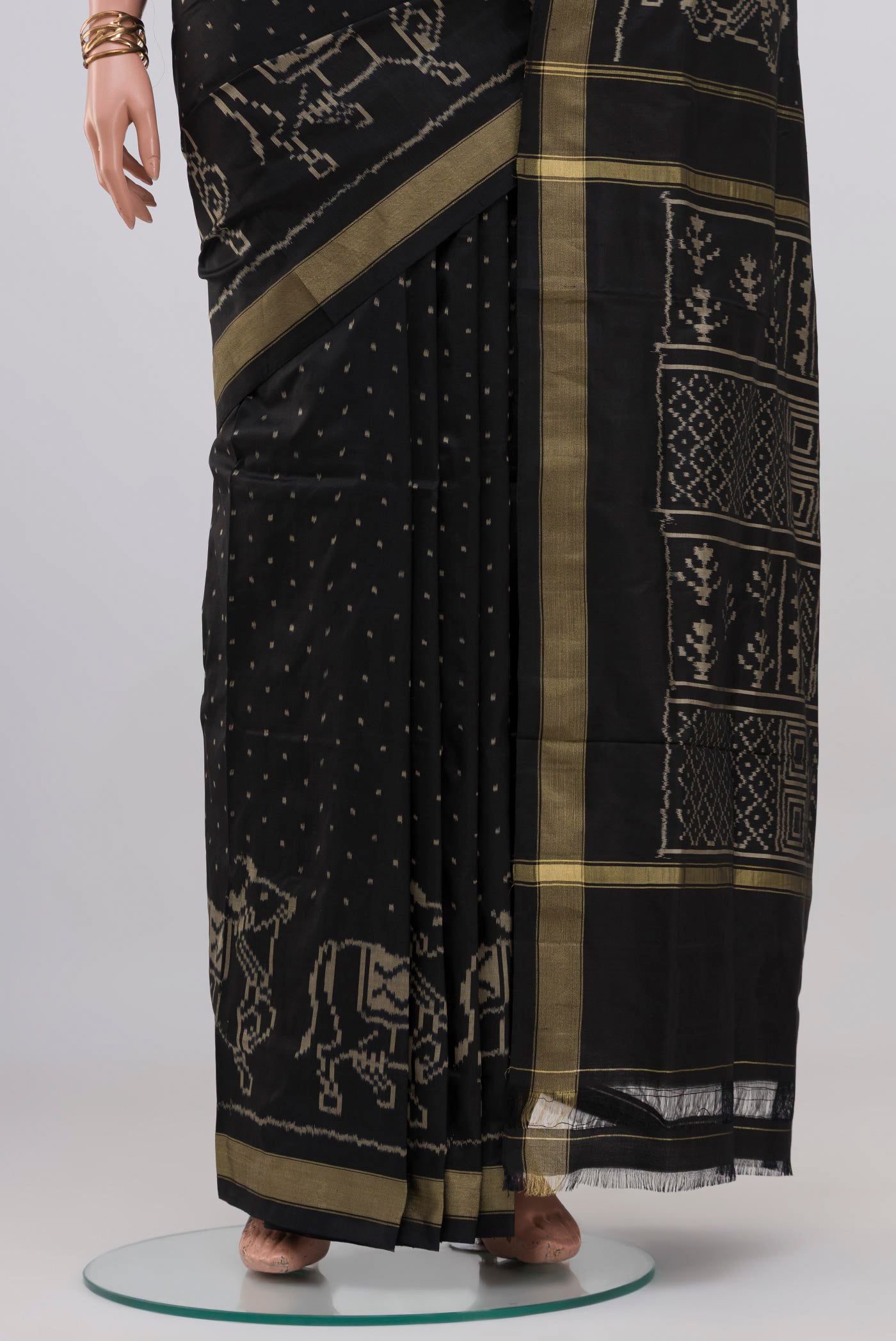 Pleats and pallu of Black Pochampally Silk Saree with Ikat design on the body and Thin Zari Line. 