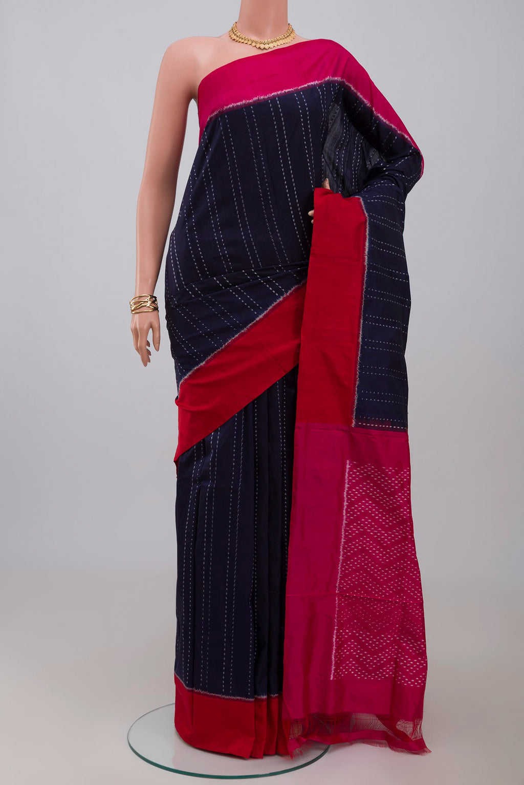 Navy Blue Pochampally Silk Saree with Ikat design on the body and Plain Border.  displayed on a mannequin