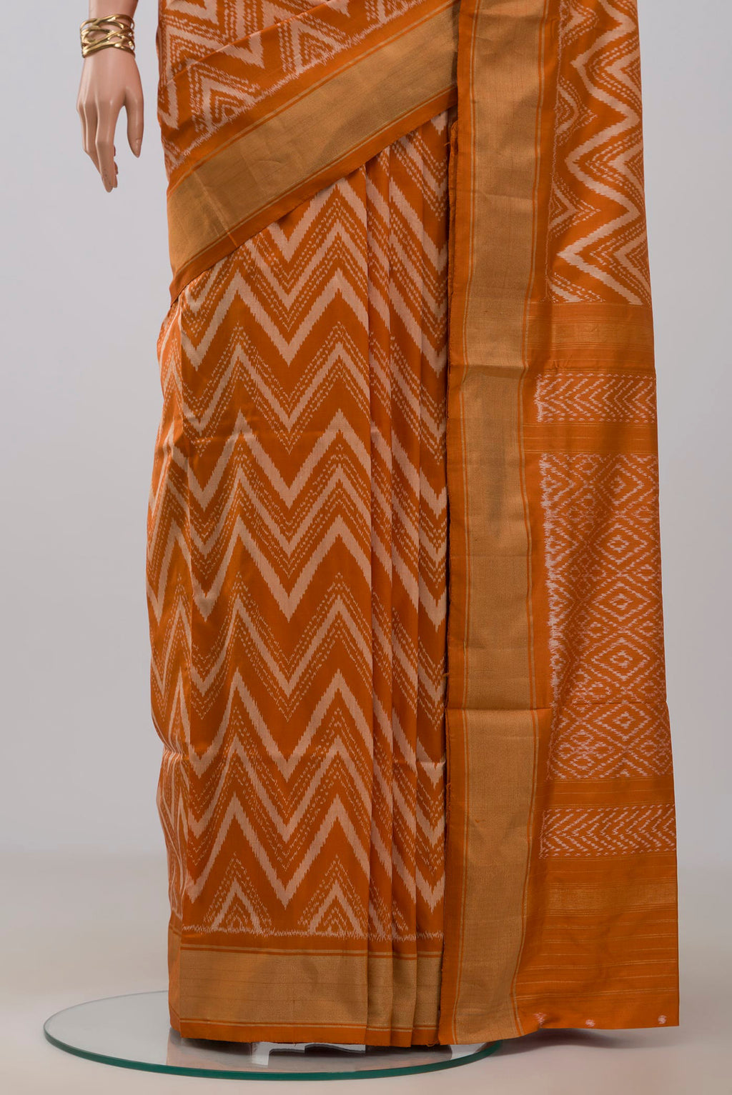 Pleats and pallu of Rust Pochampally Saree with Ikat design on the body and Zari Border. 
