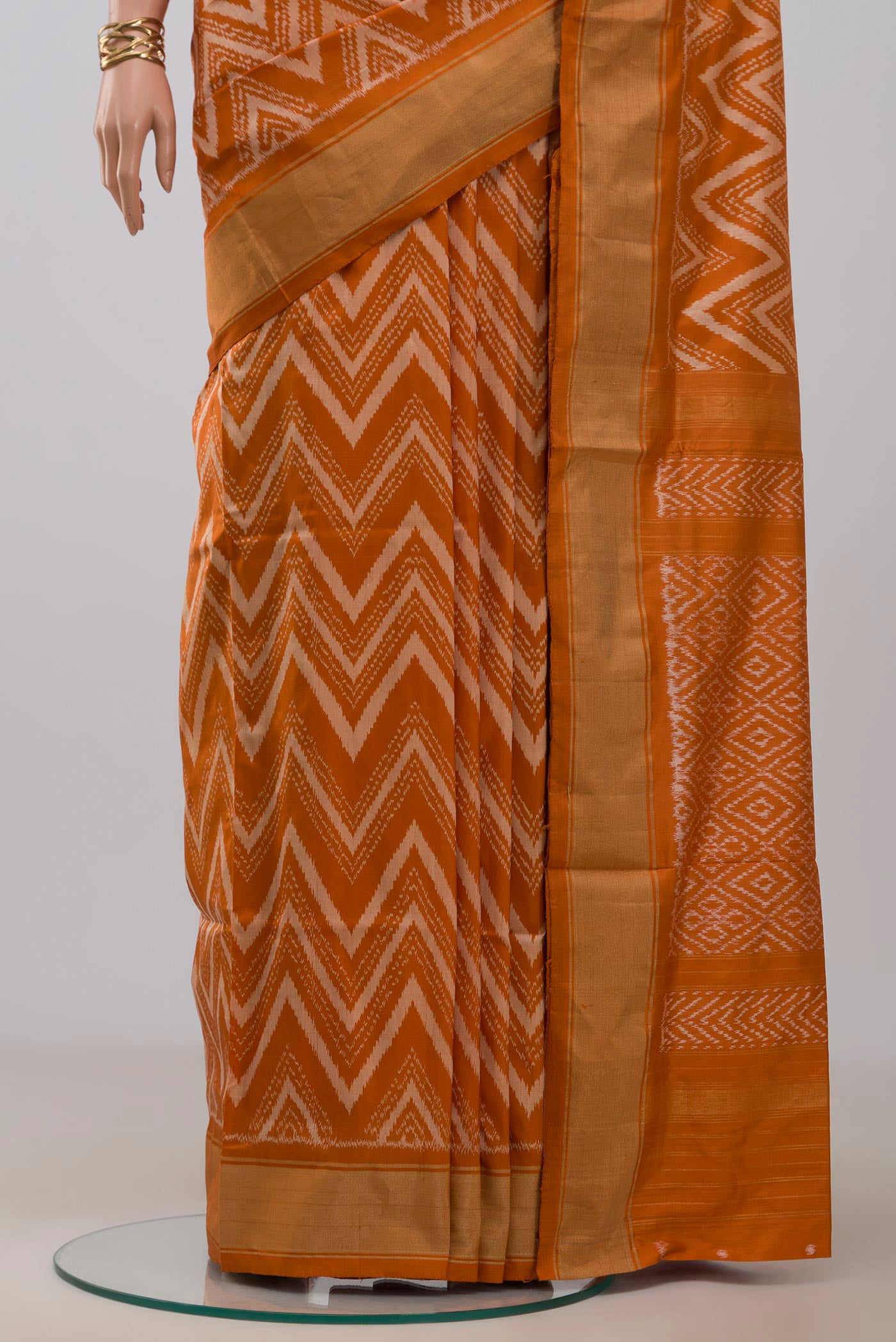 Pleats and pallu of Rust Pochampally Saree with Ikat design on the body and Zari Border. 