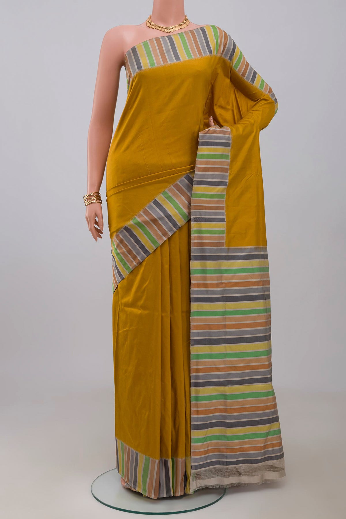 Mustard Pochampally Silk Saree with Plain Body and Plain Border.  displayed on a mannequin