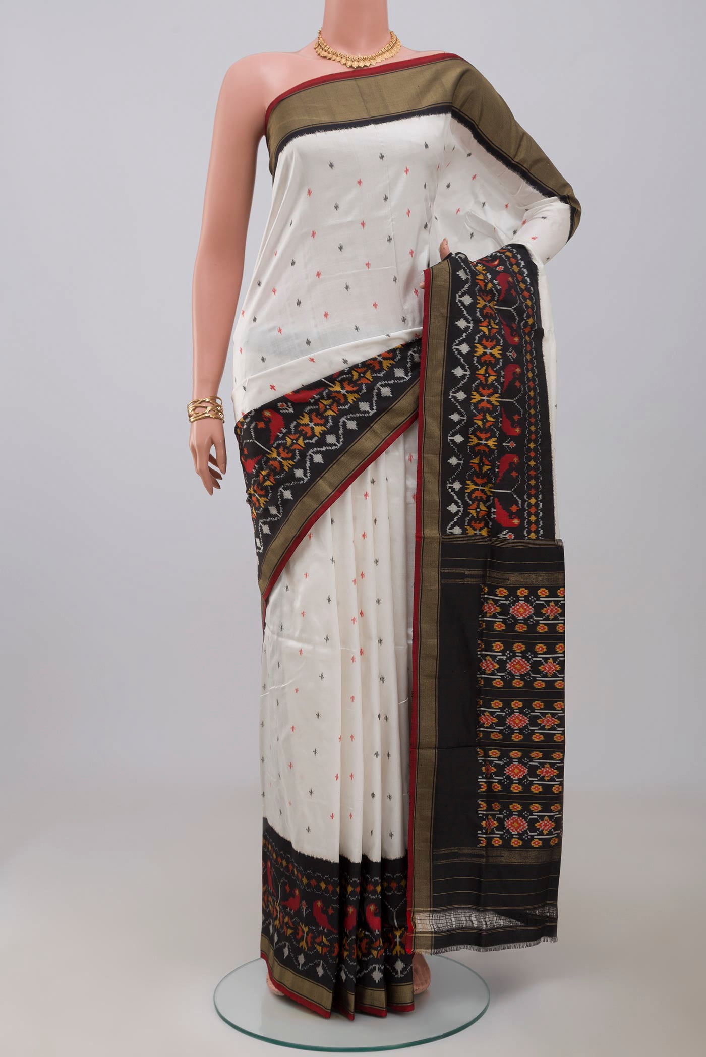 White Pochampally Saree with Ikat Print on the body and Ikat Border.  displayed on a mannequin