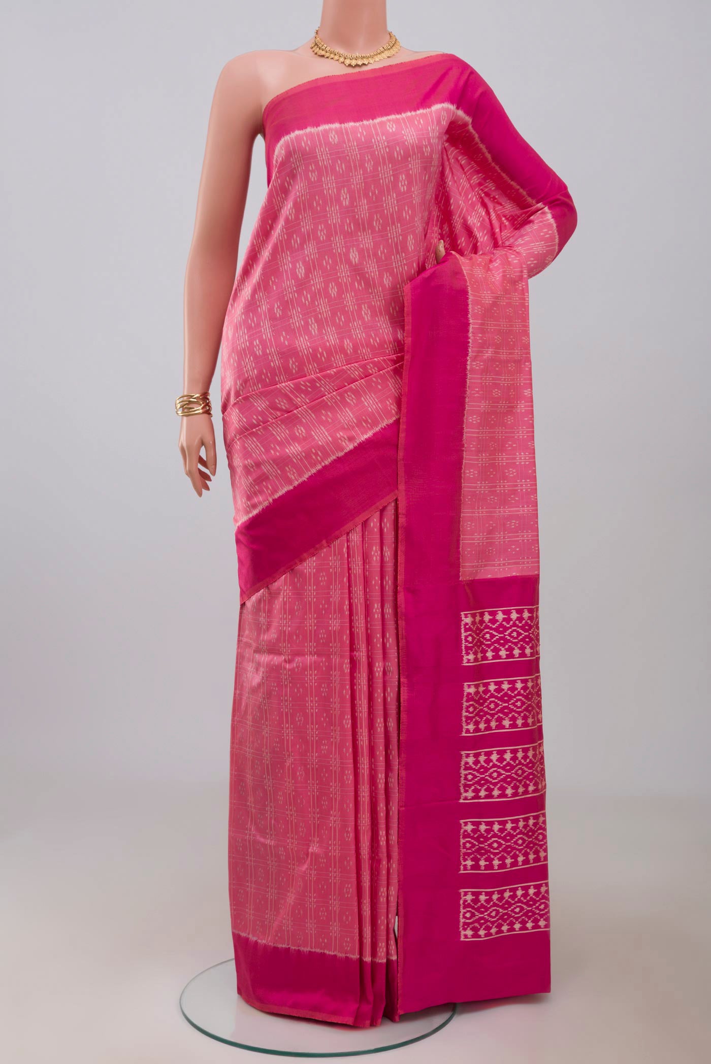 Pink Pochampally Saree with Ikat Print on the body and Plain Border.  displayed on a mannequin