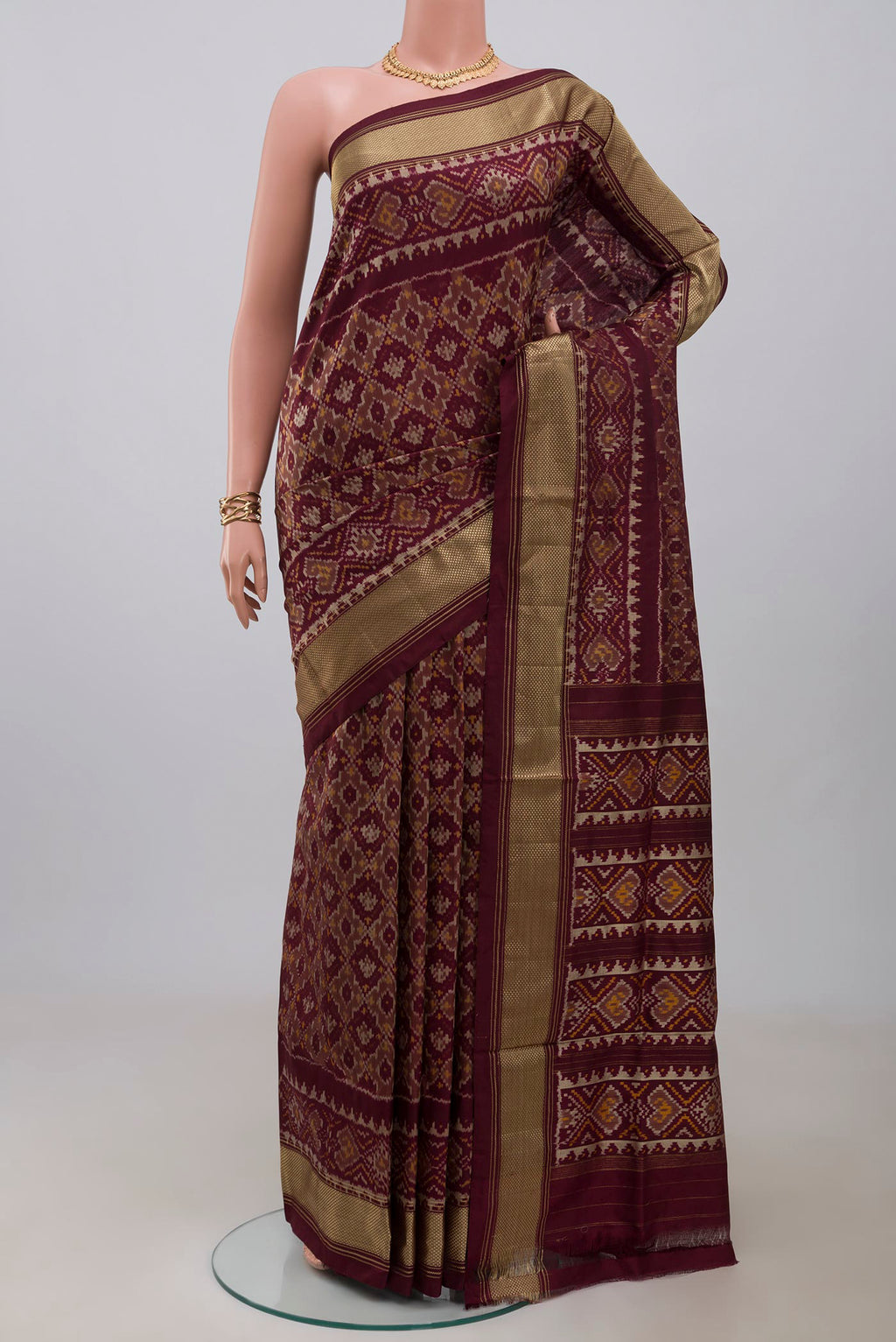 Coffee Brown Pochampally Saree with Ikat design on the body and Zari Border.  displayed on a mannequin