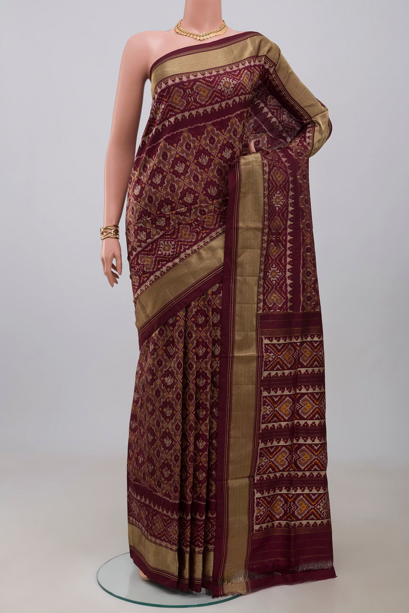 Coffee Brown Pochampally Saree with Ikat design on the body and Zari Border.  displayed on a mannequin
