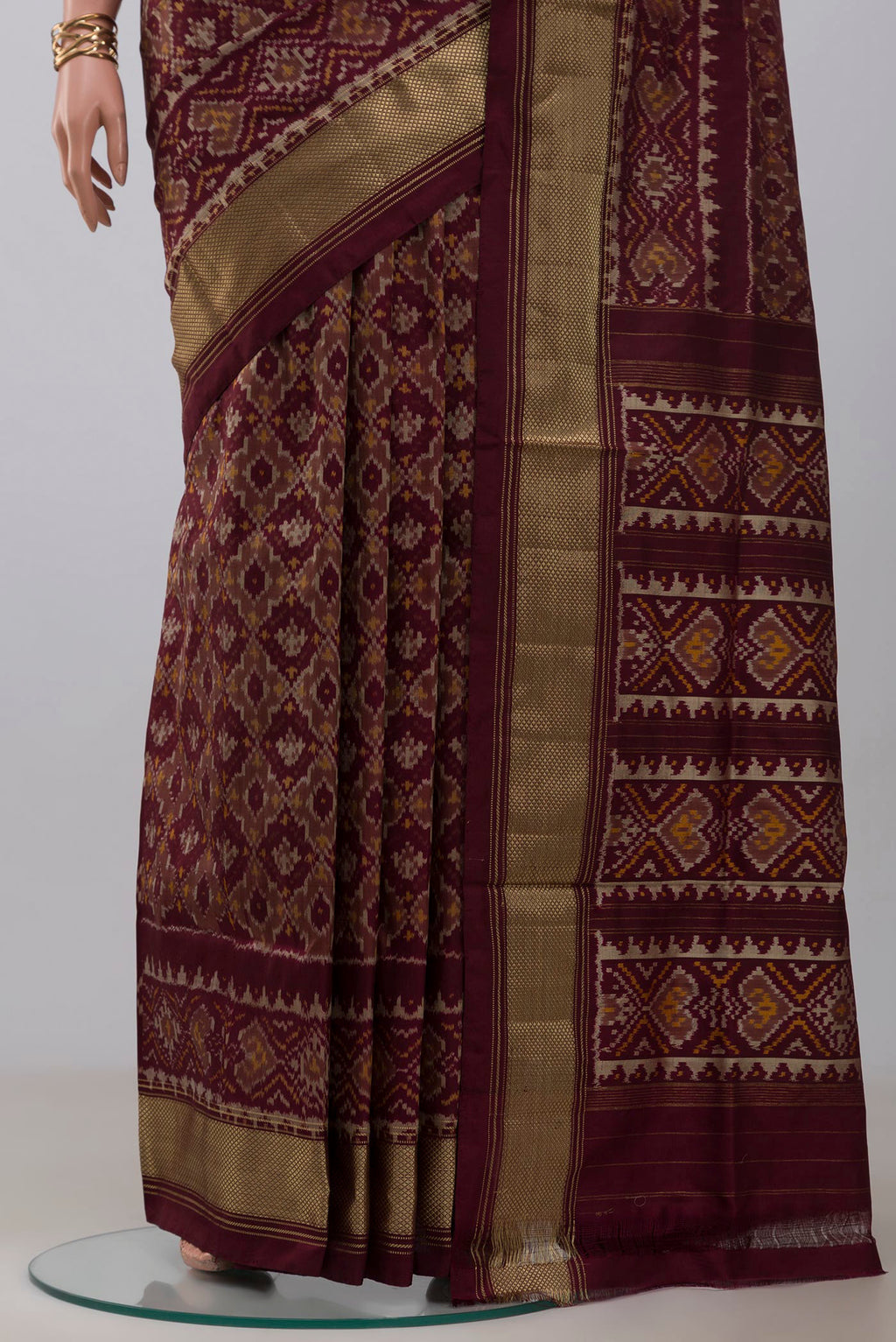 Pleats and pallu of Coffee Brown Pochampally Saree with Ikat design on the body and Zari Border. 