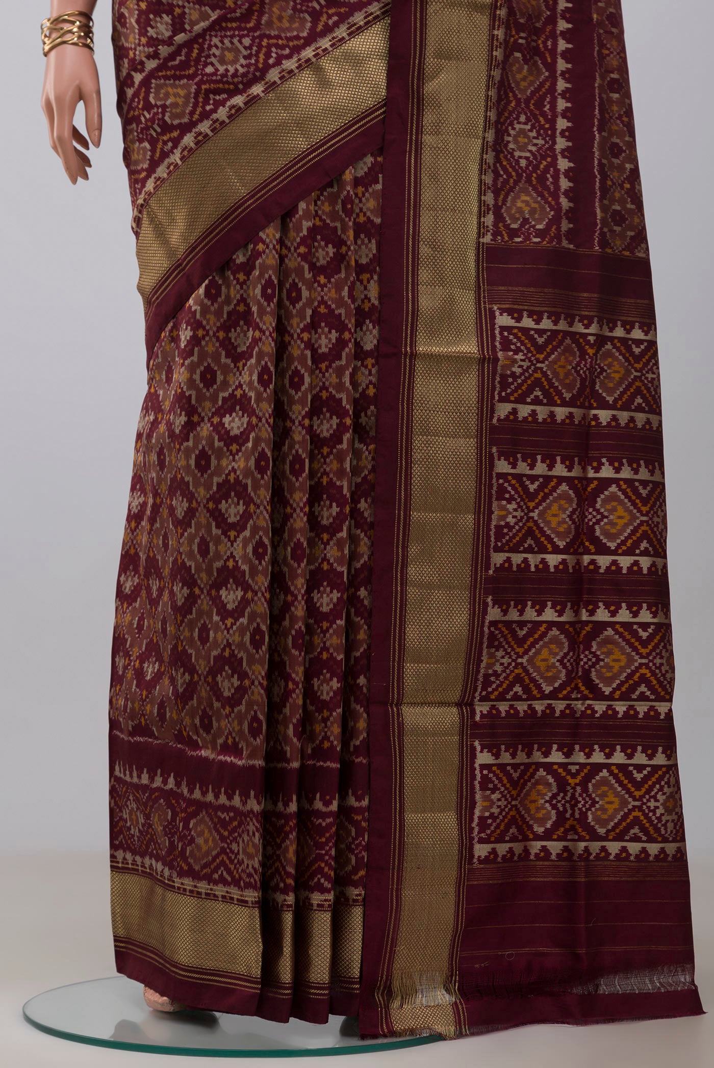 Pleats and pallu of Coffee Brown Pochampally Saree with Ikat design on the body and Zari Border. 