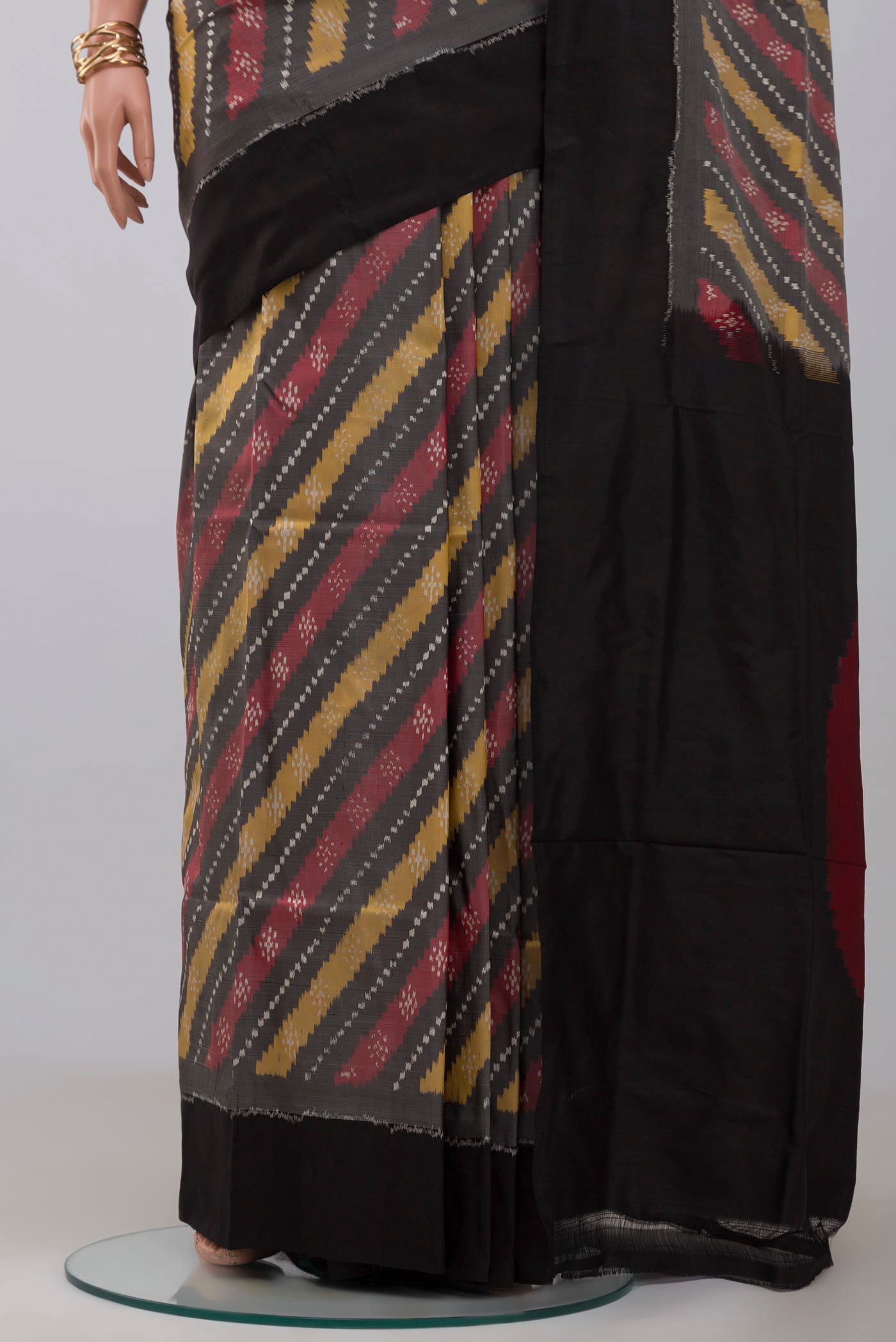 Pleats and pallu of Grey Pochampally Silk Saree with Ikat design on the body and Plain Border. 
