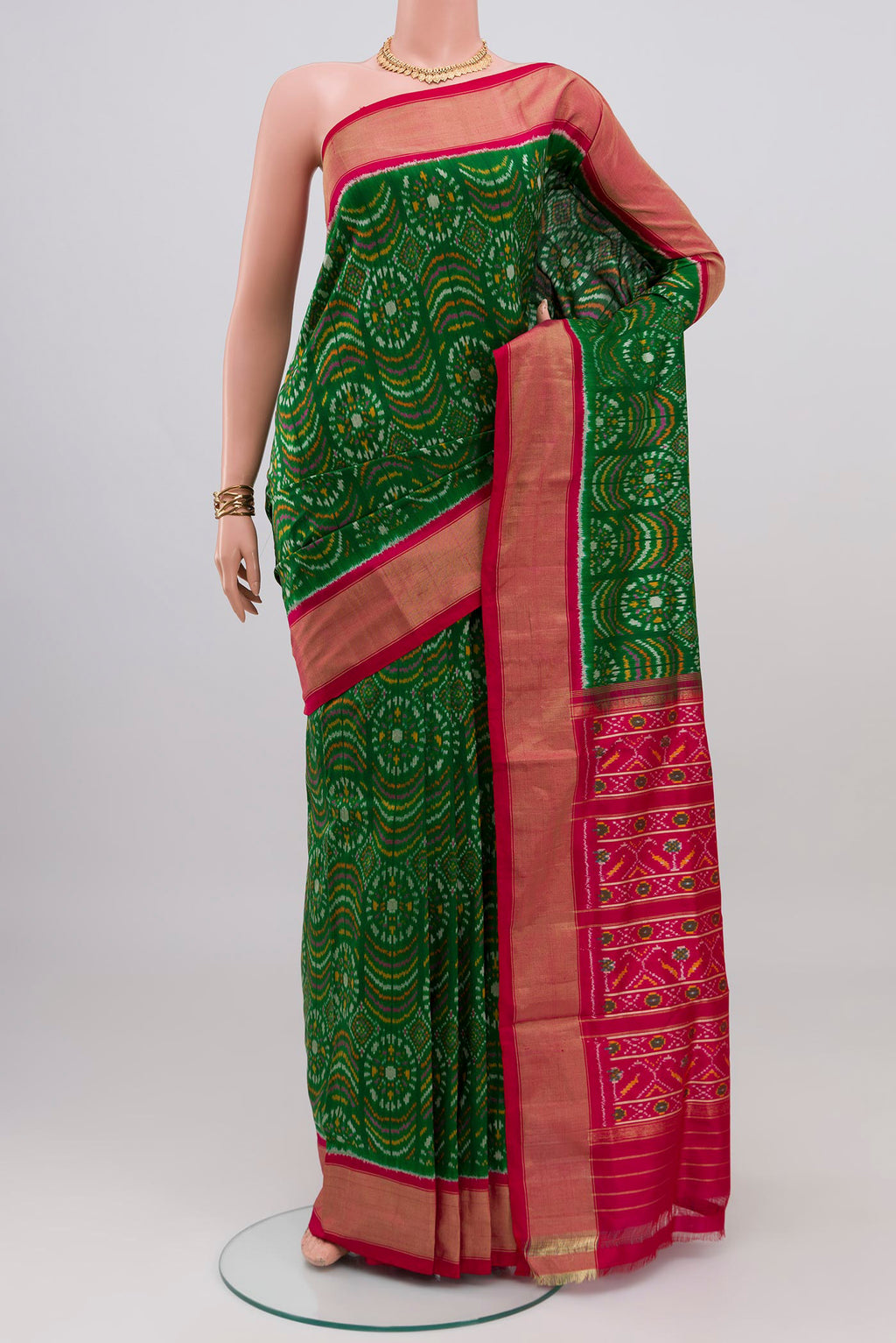 Green Pochampally Silk Saree with Ikat design on the body and Zari Border.  displayed on a mannequin