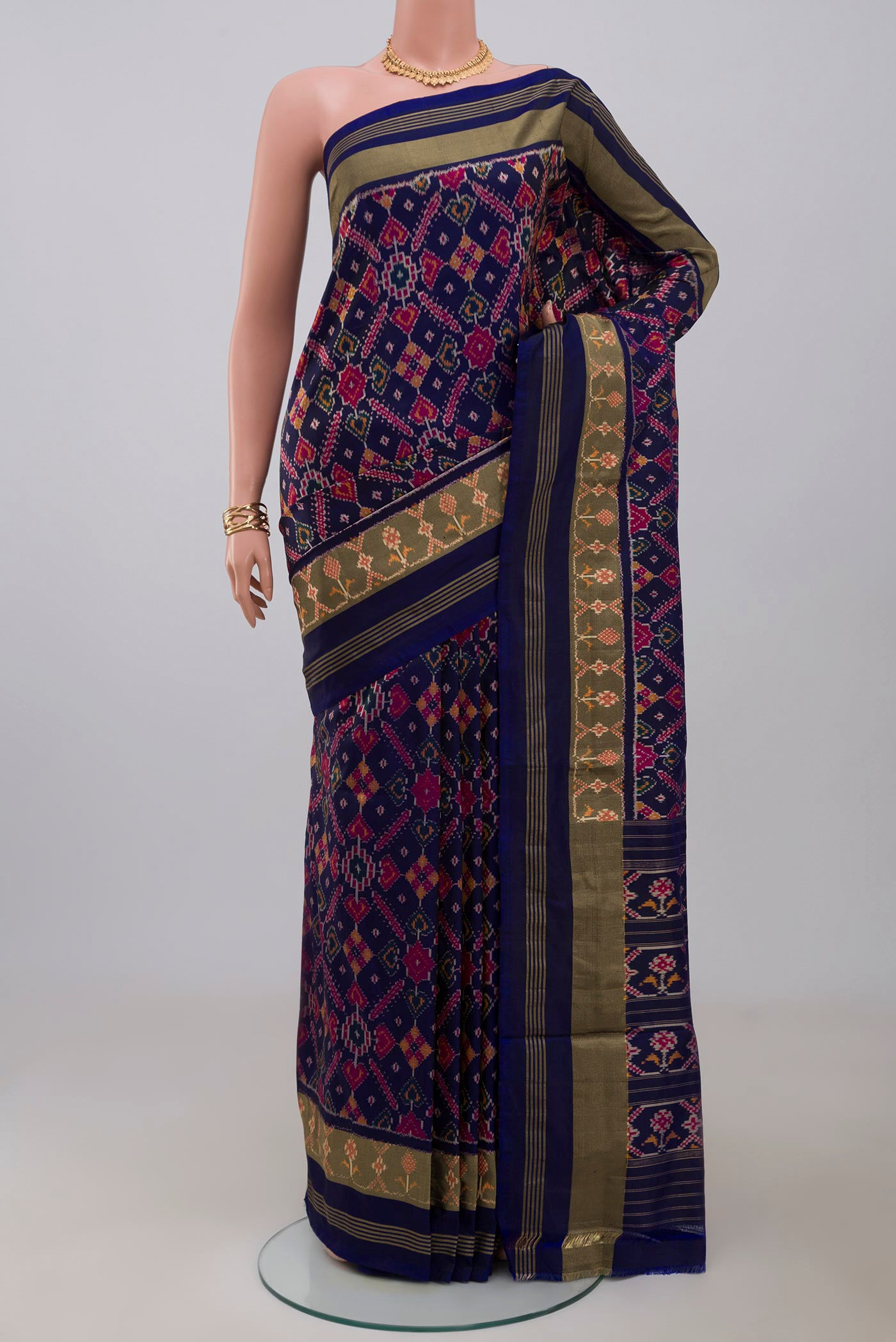 Blue Pochampally Saree with Ikat Print on the body and Zari Border.  displayed on a mannequin