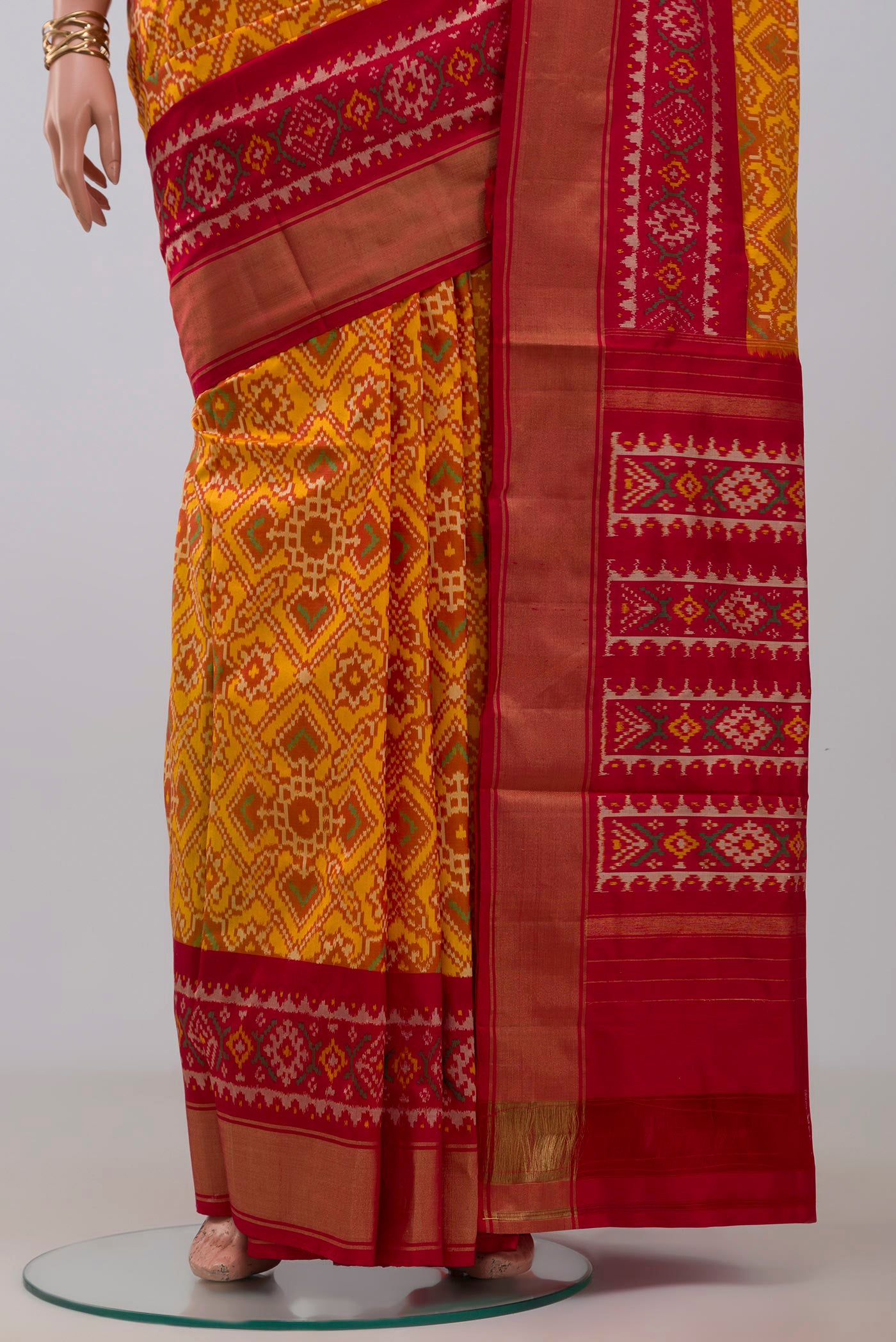 Pleats and pallu of Yellow Pochampally Silk Saree with Ikat design on the body and Zari Border. 