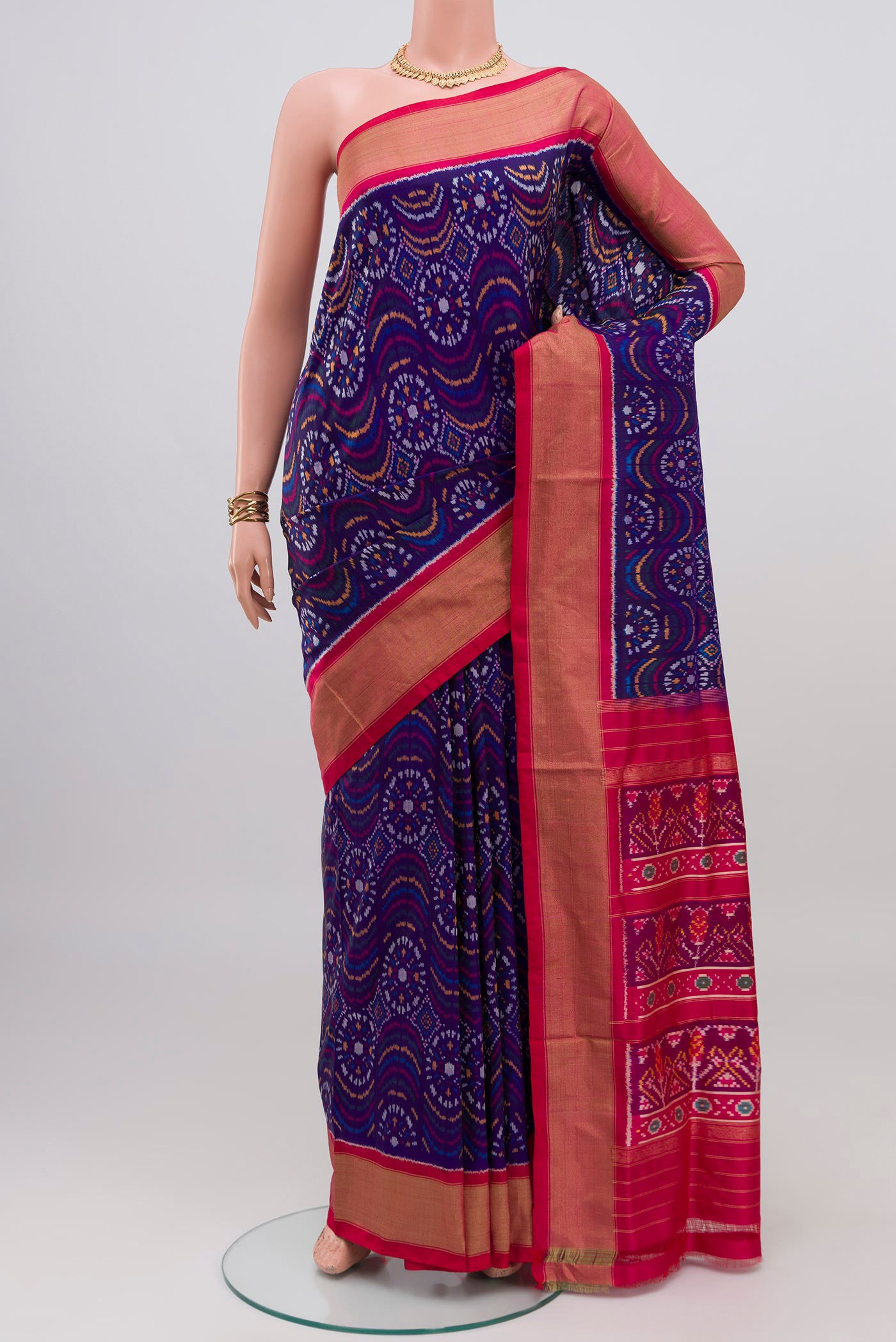 Dark Blue Pochampally Silk Saree with Ikat design on the body and Zari Border.  displayed on a mannequin