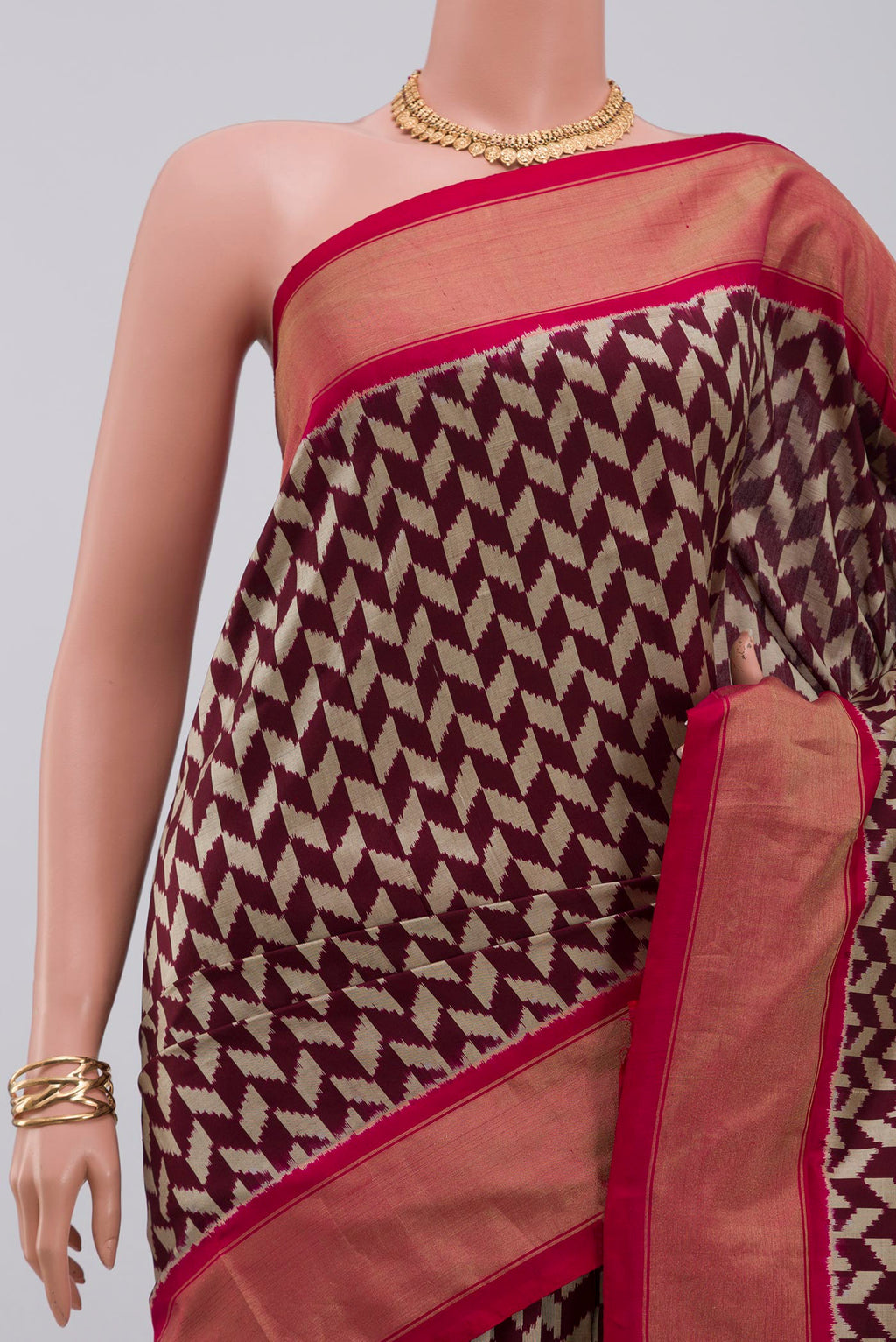 Border image of Brown Pochampally Silk Saree with Ikat design on the body and Zari Border. 