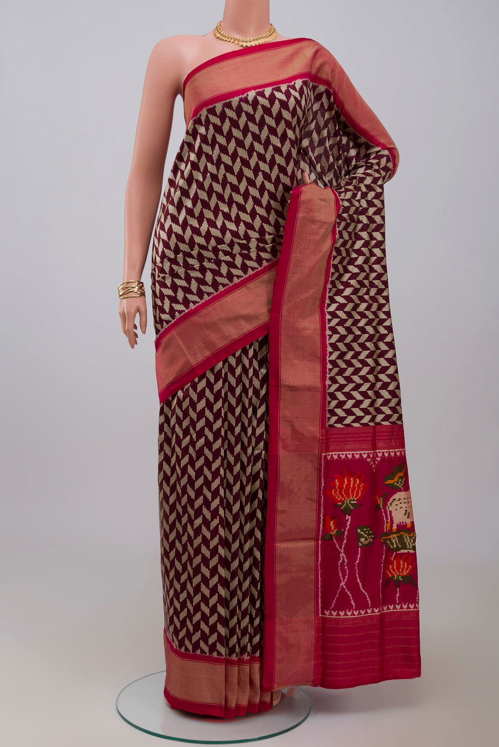 Brown Pochampally Silk Saree with Ikat design on the body and Zari Border.  displayed on a mannequin